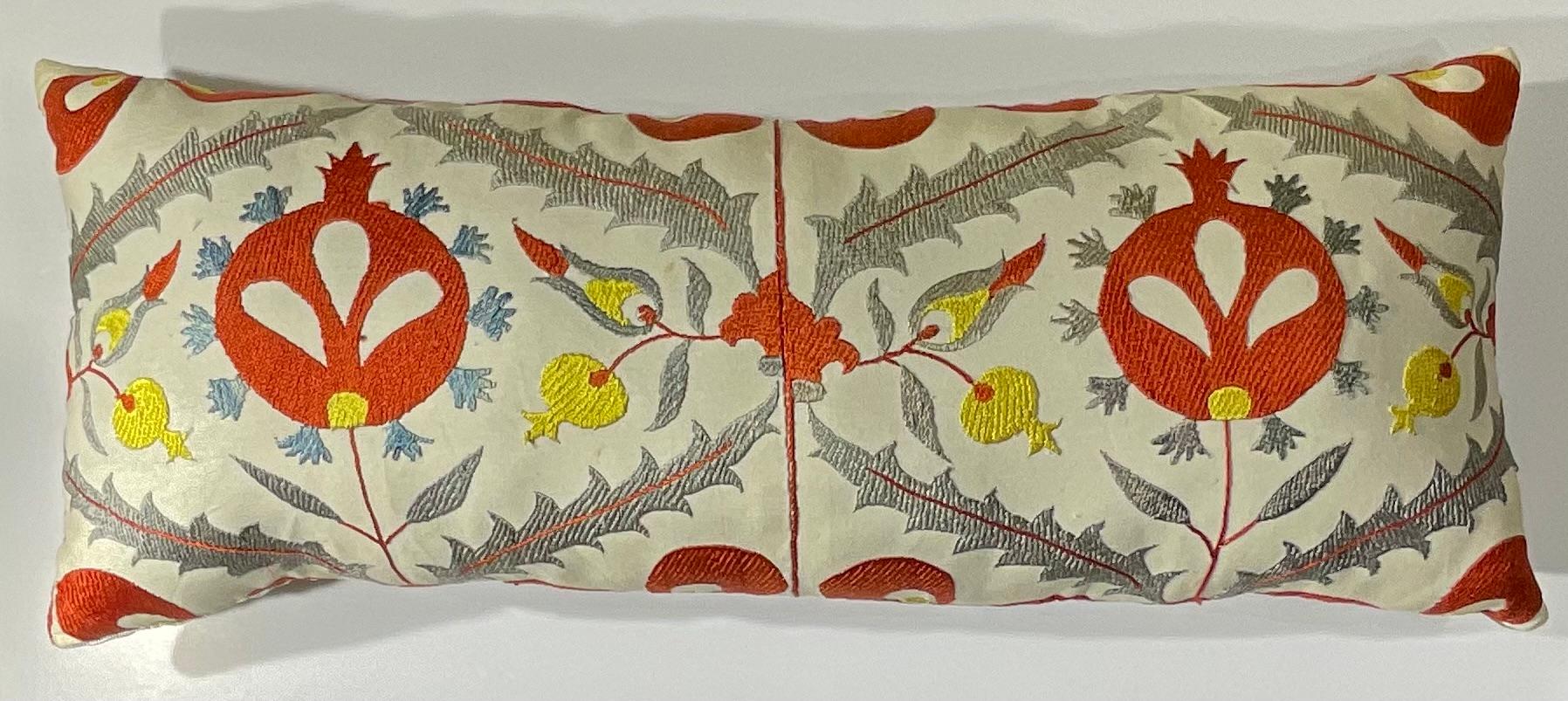 Bring a piece of Central Asian artistry into your home with this exquisite, hand-embroidered Suzani pillow. This unique decorative accent showcases the timeless beauty of traditional Uzbek craftsmanship. Every stitch tells a story, making this not