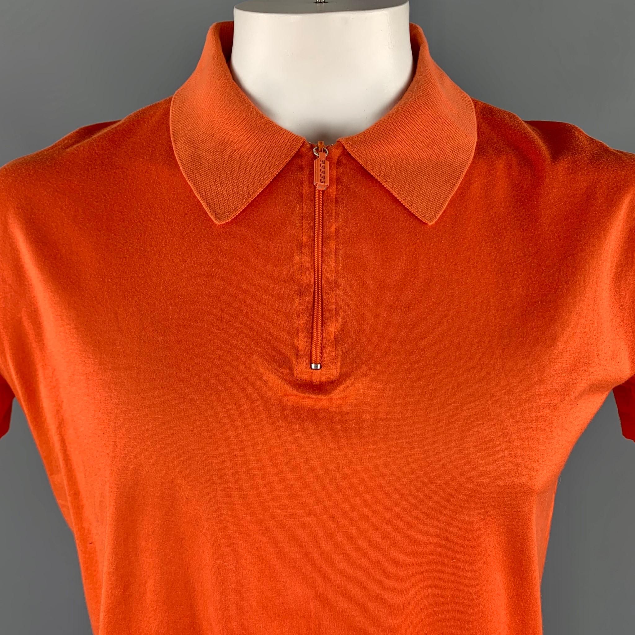Vintage V2 by VERSACE POLO comes in a solid orange cotton material, featuring a ribbed collar and a brand embroidery at front, with a half zip closure. Made in Italy.

Excellent Good Pre-Owned Condition.
Marked: L 

Measurements:

Shoulder: 18 in.