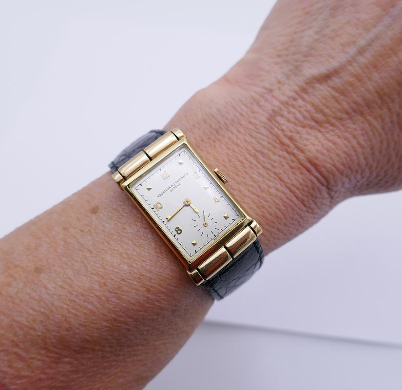 A vintage Vacheron & Constantin 14k gold unisex watch, circa 1930s.
The vintage watch features a rectangular 14 karat yellow gold case with hooded scroll lugs.
The white dial has the gold hands, gold Arabic numerals and square hour markers. The