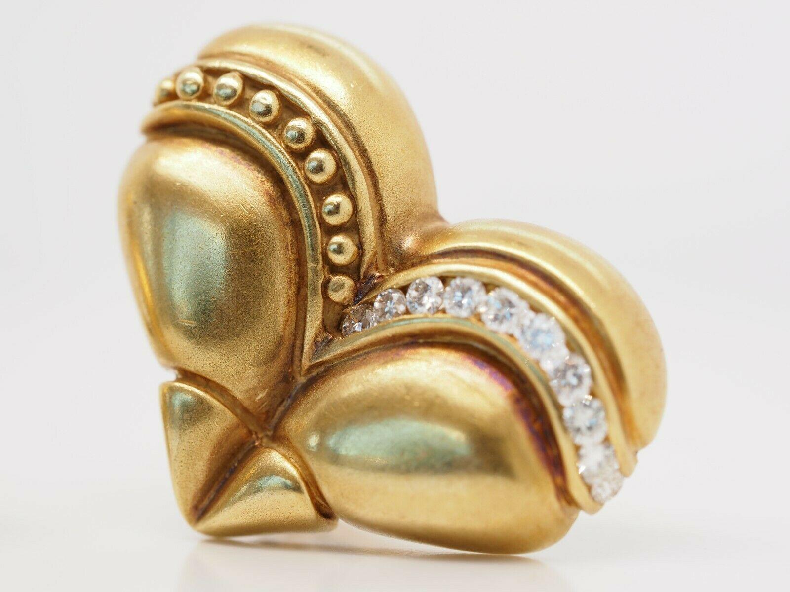 Pictured is an adorable pair of vintage 18 karat clip on heart earrings. The earrings have a formation of 18 karat beads and diamond detailing on the arches of the hearts. On the backside there is a 