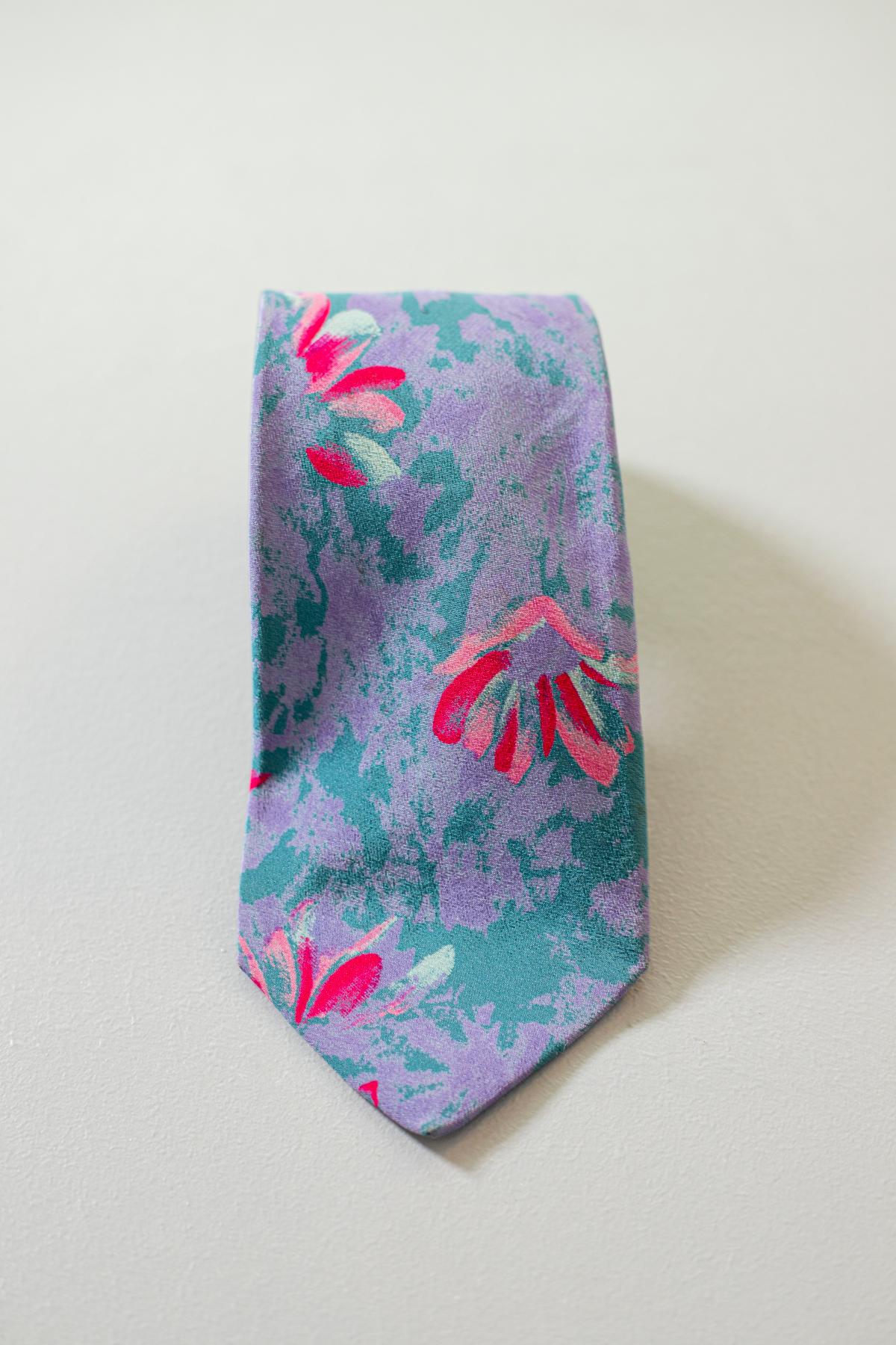A true evergreen, this tie is designed by the famous fashion designer Valentino, reflects the great Italian taste in fashion. This vintage all silk tie is colorful, yet classic. decorated with shades of colors, mainly on lilac, with slightly