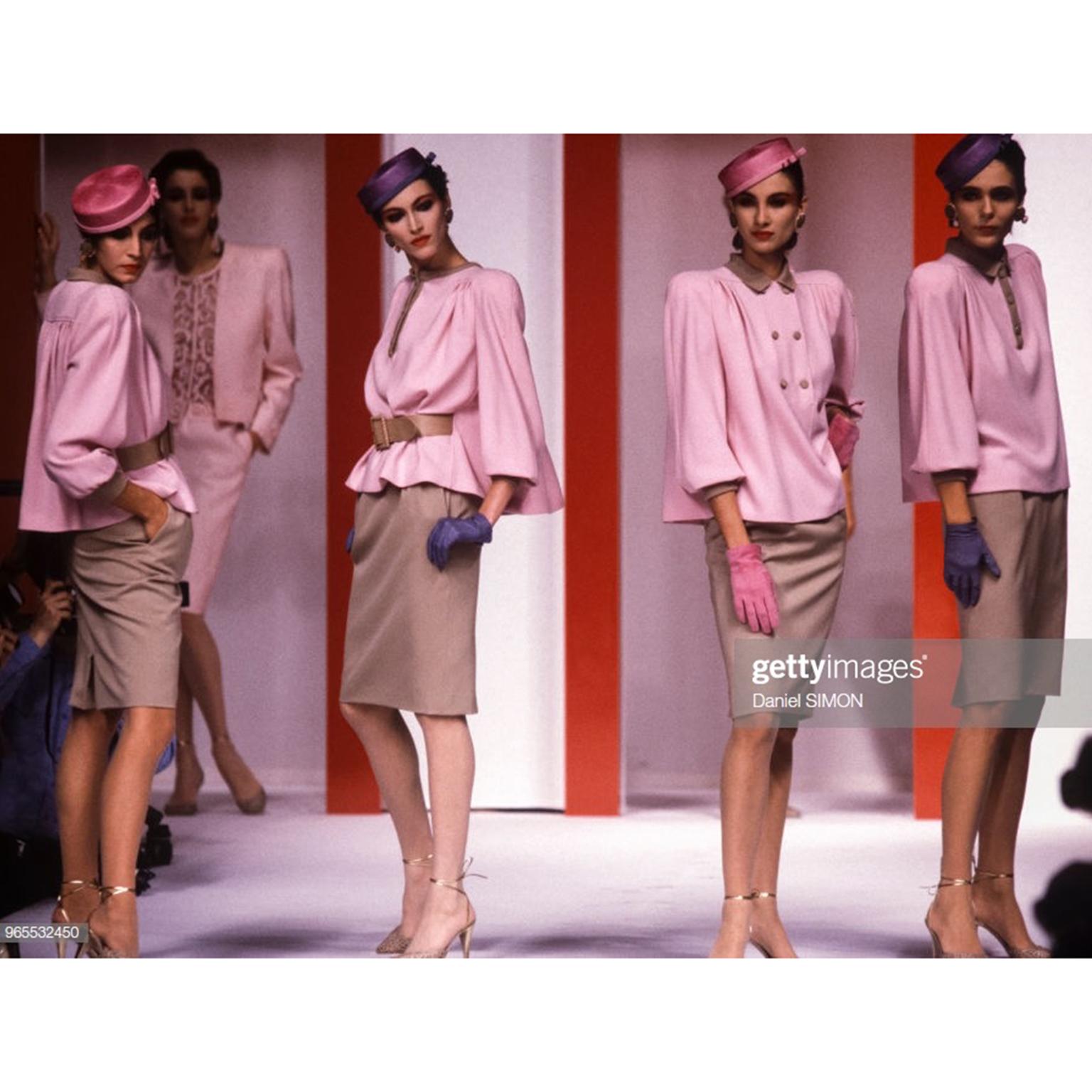 This incredible 2 piece outfit is from the Fall Winter 1984 collection for Valentino. This vintage suit has a pink crepe swing top with matching belt and a beige / camel colored skirt. The top has a gathered full back and can be worn in a number of