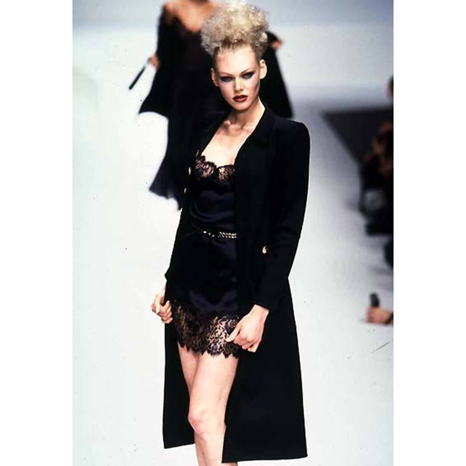 This is a gorgeous black silk vintage Valentino slip dress with lace trim from 1997. Kylie Bax wore the dress with a belt on the runway for Valentino's Spring Summer 1997 show. This iconic slip dress has the lace design detail along the top and at