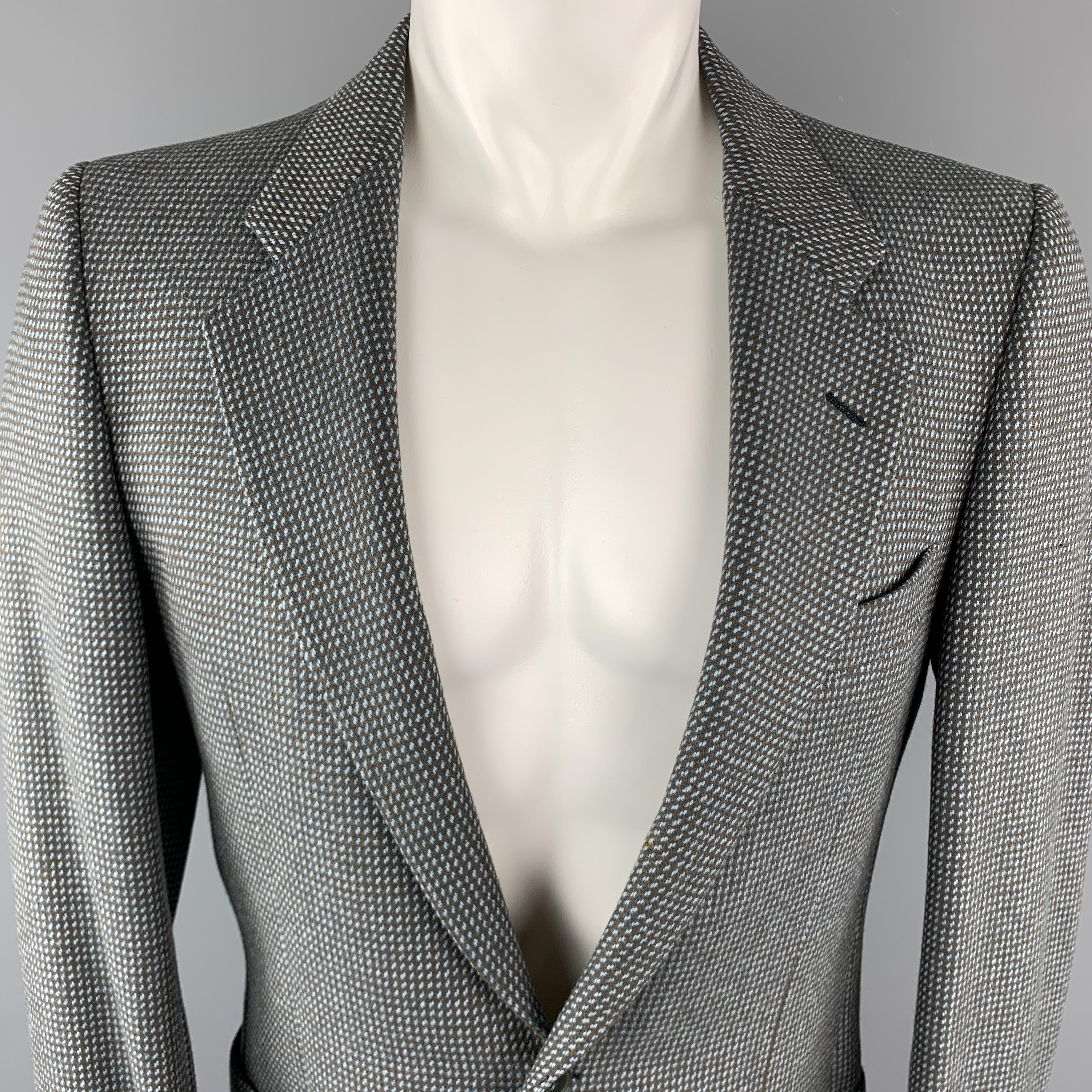 Vintage VALENTINO Sport Coat comes in a taupe and grey tone in a nailhead wool / cashmere material, with a notch lapel, slit and patch pockets, two buttons at closure, buttoned cuffs, and a single vent at back. With a very light spot inside the