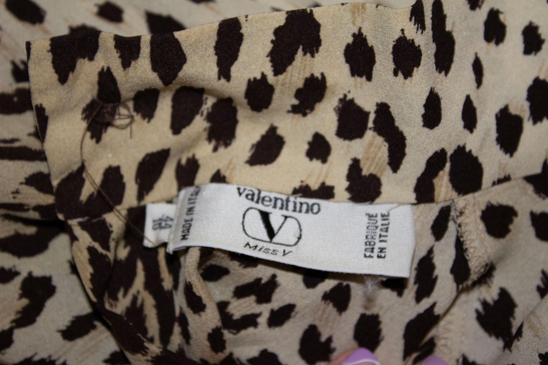 A chic and easy to wear vintage silk blouse from Valentino. The blouse is in an attractive animal print and has a button back, single button cuff, and fold at the front. Italian size 44 / UK 10.
Measurements; Bust  up to 40'', length 25''
