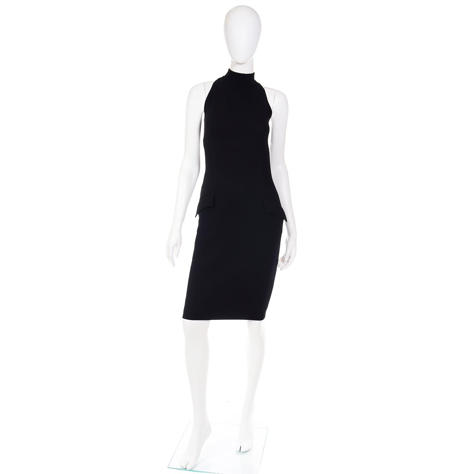 This is such an incredible vintage Valentino boutique black crepe sleeveless bodycon dress with faux side flap pockets and a center back zipper with rhinestones that unzips from both the top and bottom. This beautiful mock turtleneck dress is fully