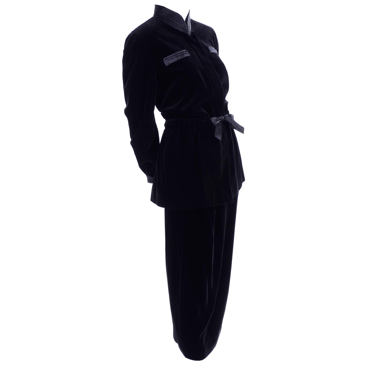 This is a beautiful Valentino Boutique black velvet skirt suit with a pencil skirt and belted smoking jacket. The pretty jacket ties at the waist and has hidden buttons up the front., ribbed satin on the high collar and trim on the cuffs, and