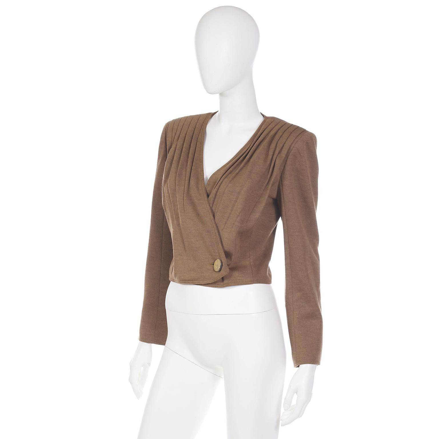 This vintage unworn deadstock Valentino boutique jacket is in a light brown wool blend and has so much style! This great fully lined, cropped jacket has beautiful front pleating starting at the shoulders. The jacket has a wrap closure at the waist