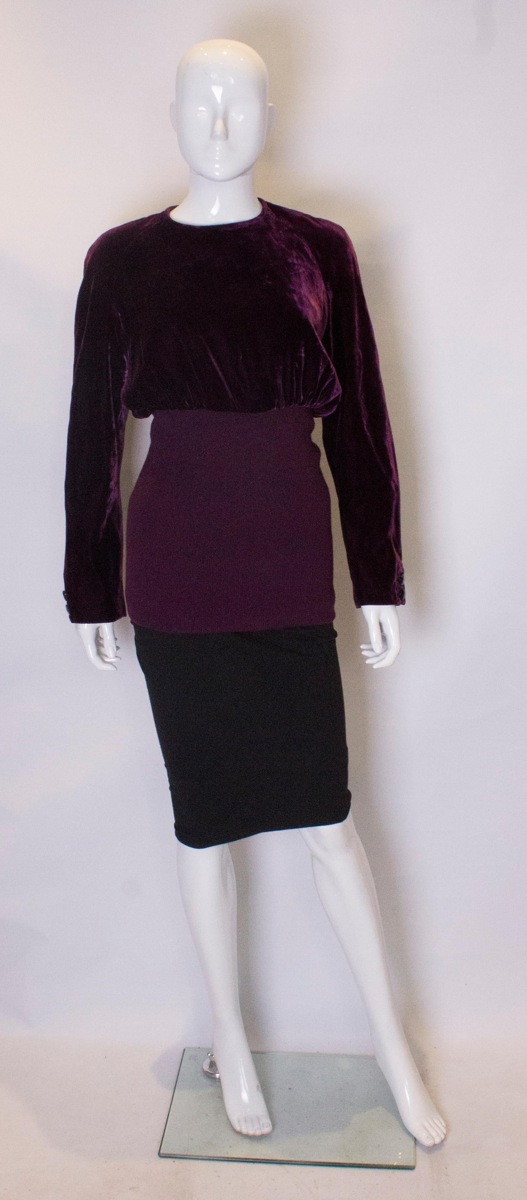   A lovely vintage velvet top by Valentino , Boutique line. The top has a zip central back opening, and is fully lined. There are two buttons on each cuff, and a deep rib band of 15'' at the lower area.
