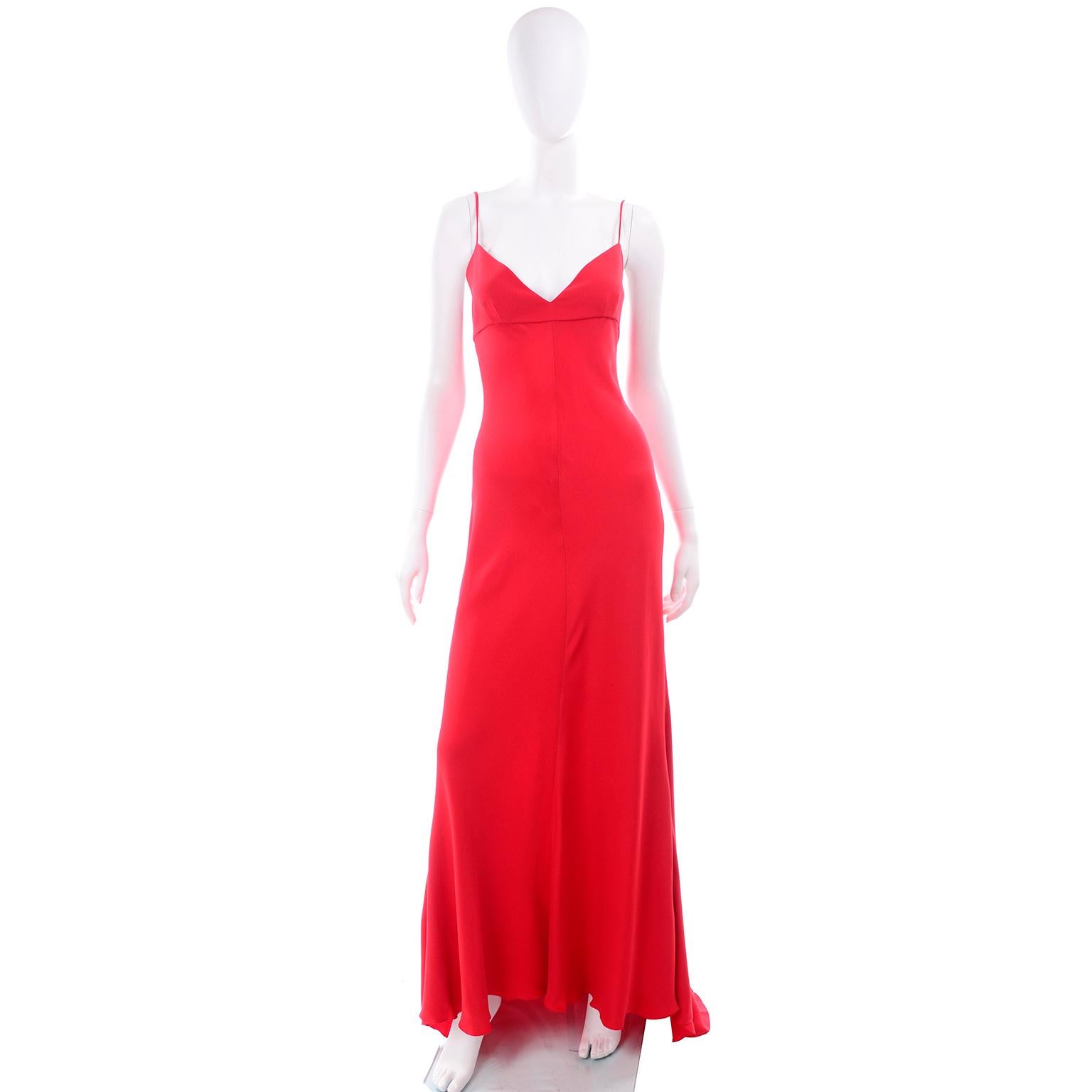 This is an absolutely gorgeous Valentino red vintage slip dress. This beautiful silk evening gown has spaghetti straps, an empire waist, and closes with a metal zipper and hook and eye on that center back seam. The dress has a slight train and is