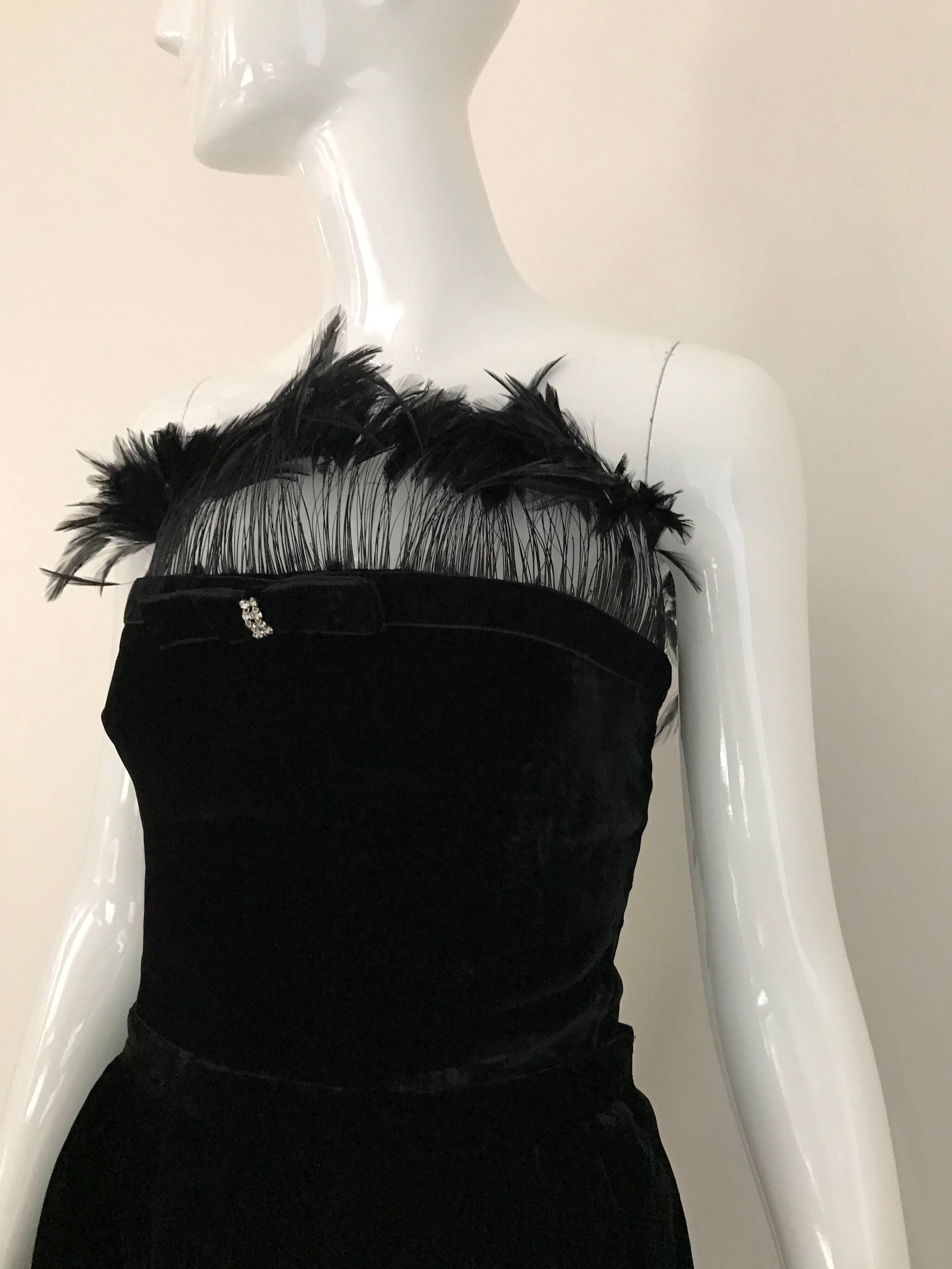 Elegant and fun Late 80s Vintage Valentino black velvet bustier top with feathers and rhinestones bow. Skirt has an asymmetrical cut. Bustier and skirt has zipper on the side.
Small size ( 2/ 4 )
Bust: 34 inches/ Skirt Waist : 26 inches