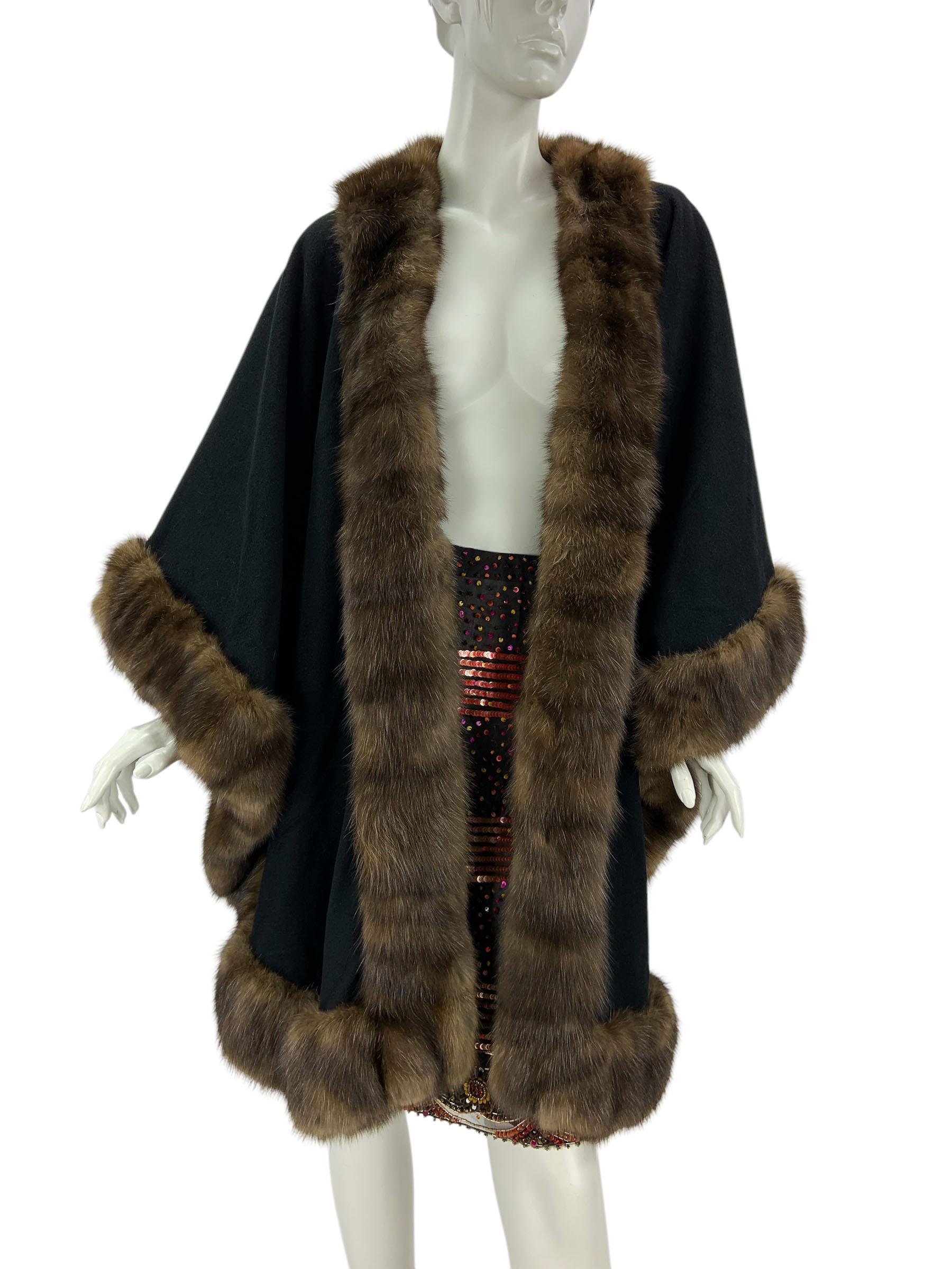 Vintage Valentino Couture by Alixandre Sable Trim Cape 
Black cashmere cape with sable trim. One hook closure. One size.
Measurements approx: length - front 36 inches , back 31