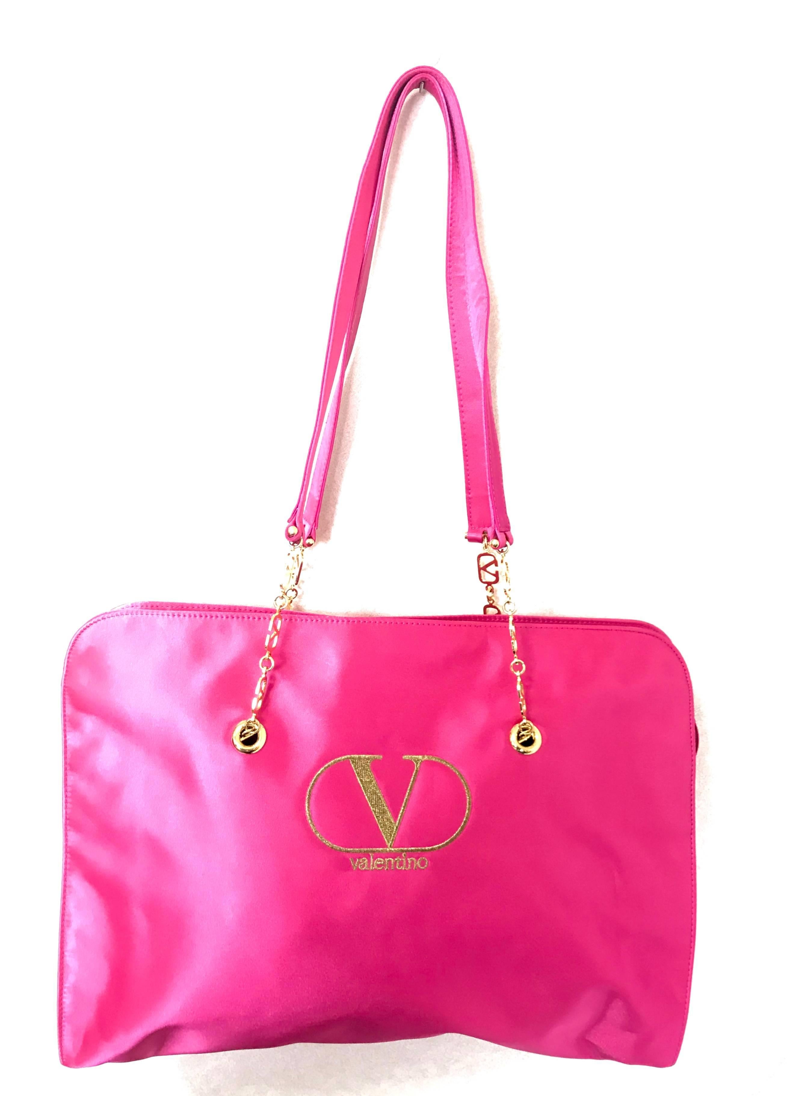 1990s. Vintage Valentino Garavani pink satin large tote bag with gold tone V logo chain straps. Good for daily bag.

This is a vintage tote bag from the VALENTINO GARAVANI ACCESSORIES collection back in the 90's.
Beautiful bright pink
