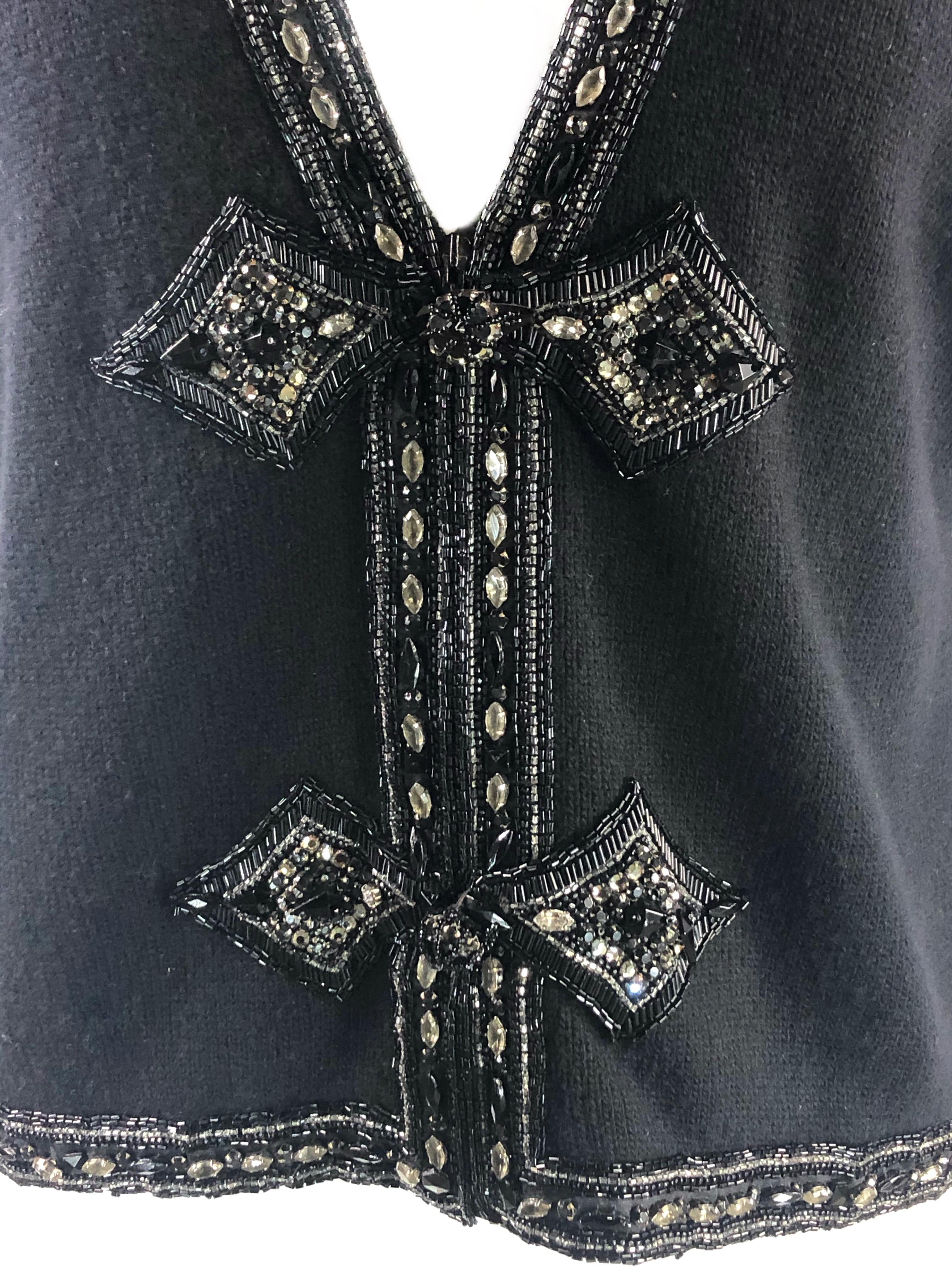 Vintage VALENTINO Night Black Knit Vest w/ Rhinestone Size M

Product details:
Size M
Front zip closure, measures 11” long
Rhinestone detail 
Made in Italy
