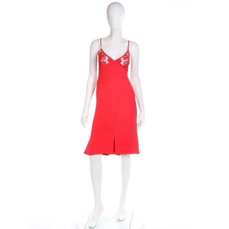 This stunning vintage Valentino red slip dress is in a beautiful, luxe silk crepe with a lace bustline and spaghetti straps. The dress is fully lined below the bust and we especially love the cutouts at the hemline that have lace inserts underneath.