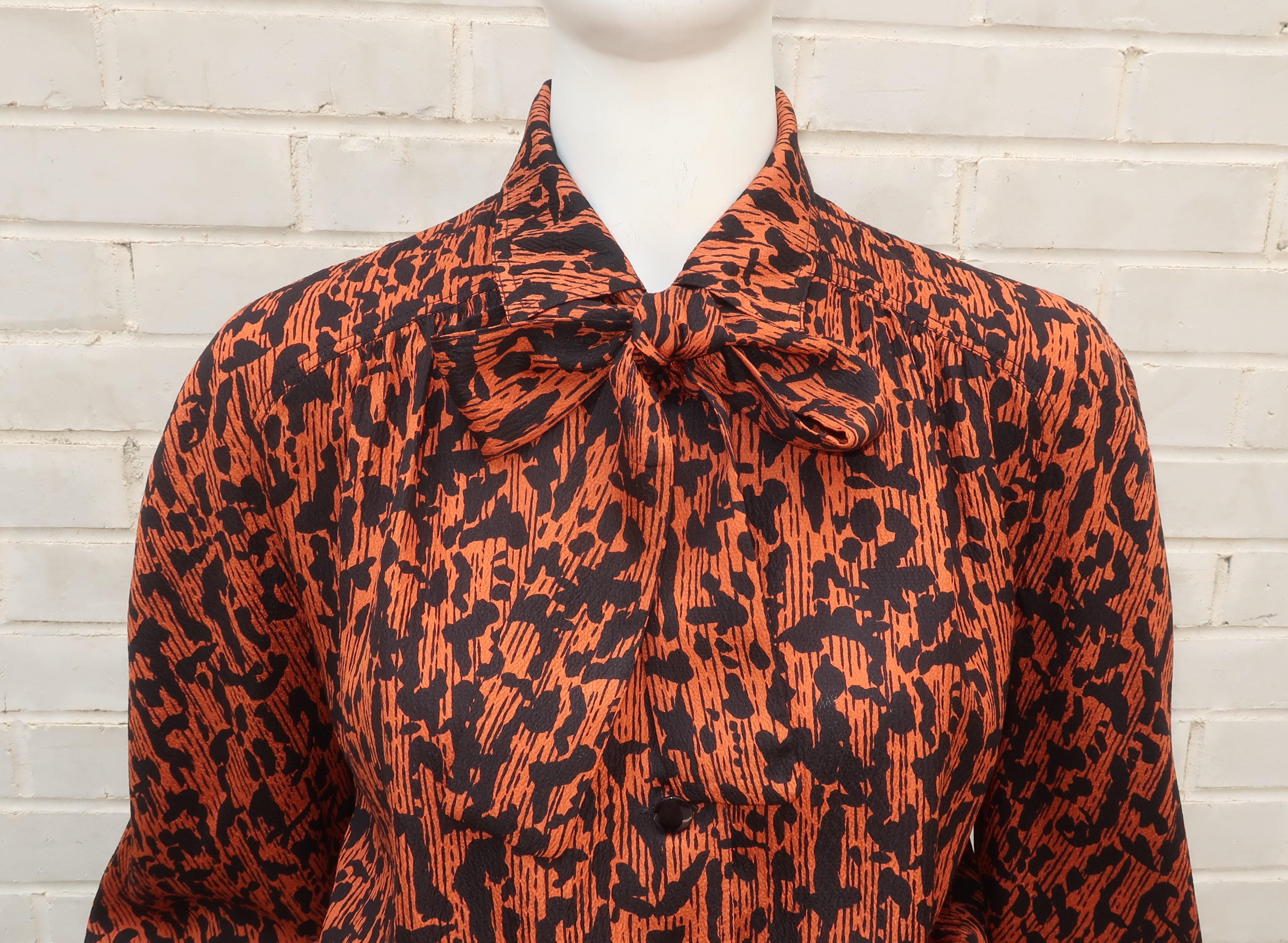 Why wear something simple when you can wear Valentino!  It may simply be a nice silk crepe blouse but add a yoke at the waist, a stock tie at the neck and an abstract animal print in black and rusty brown and ... voila! ... Valentino magic.  It