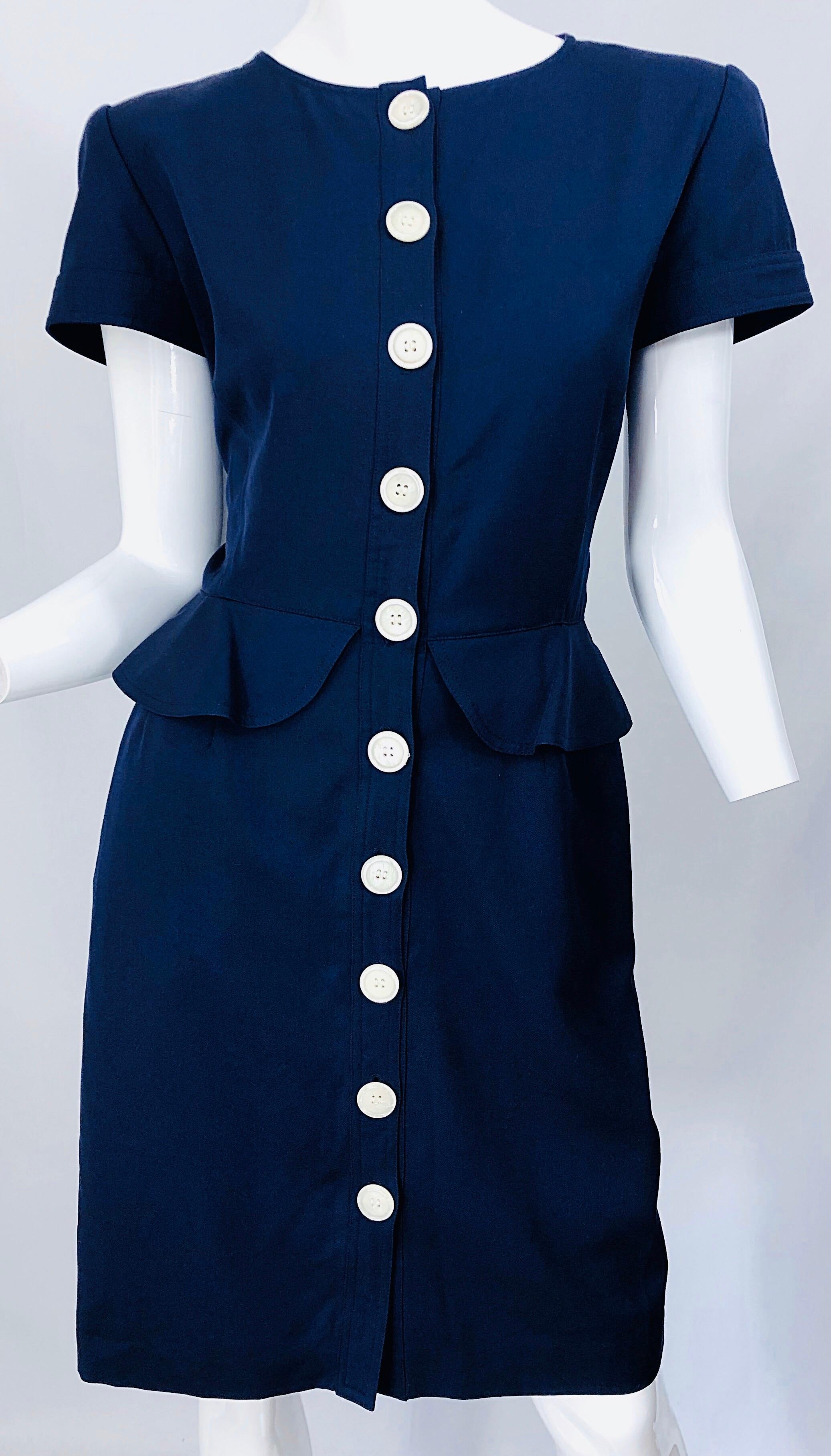 Chic and classic vintage 80s VALENTINO navy blue short sleeve Size 10 peplum nautical dress! Features a tailored bodice with a flattering peplum at waist and forgiving pencil skirt. POCKETS at each side of the waist. White buttons up the front. Can