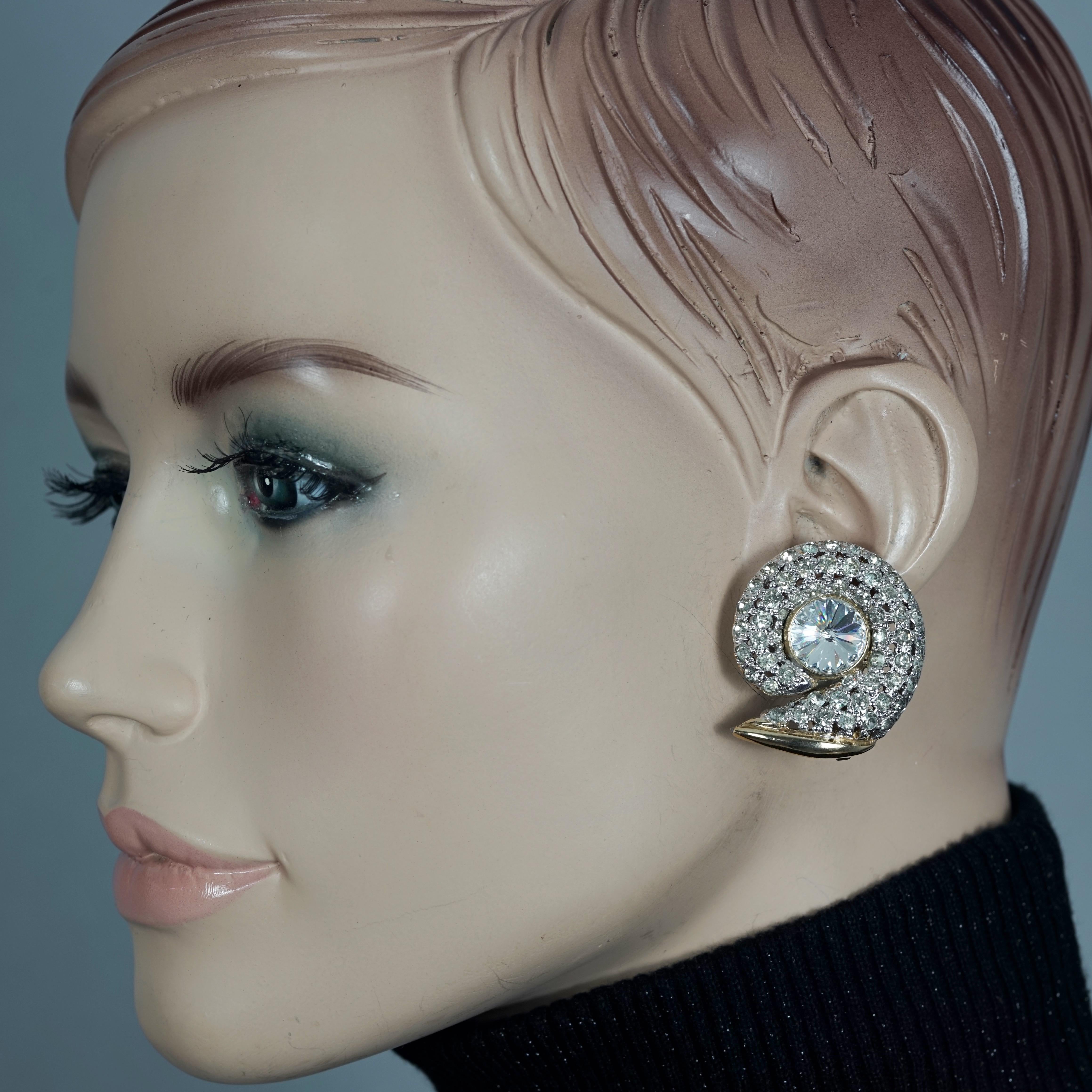 Vintage VALENTINO Snail Rhinestone Earrings

Measurements:
Height: 1.38 inches (3.5 cm)
Width: 1.22 inches (3.1 cm)
Weight per Earring: 14 grams

Features:
- 100% Authentic VALENTINO.
- Snail earrings studded with clear rhinestones.
- Gold tone