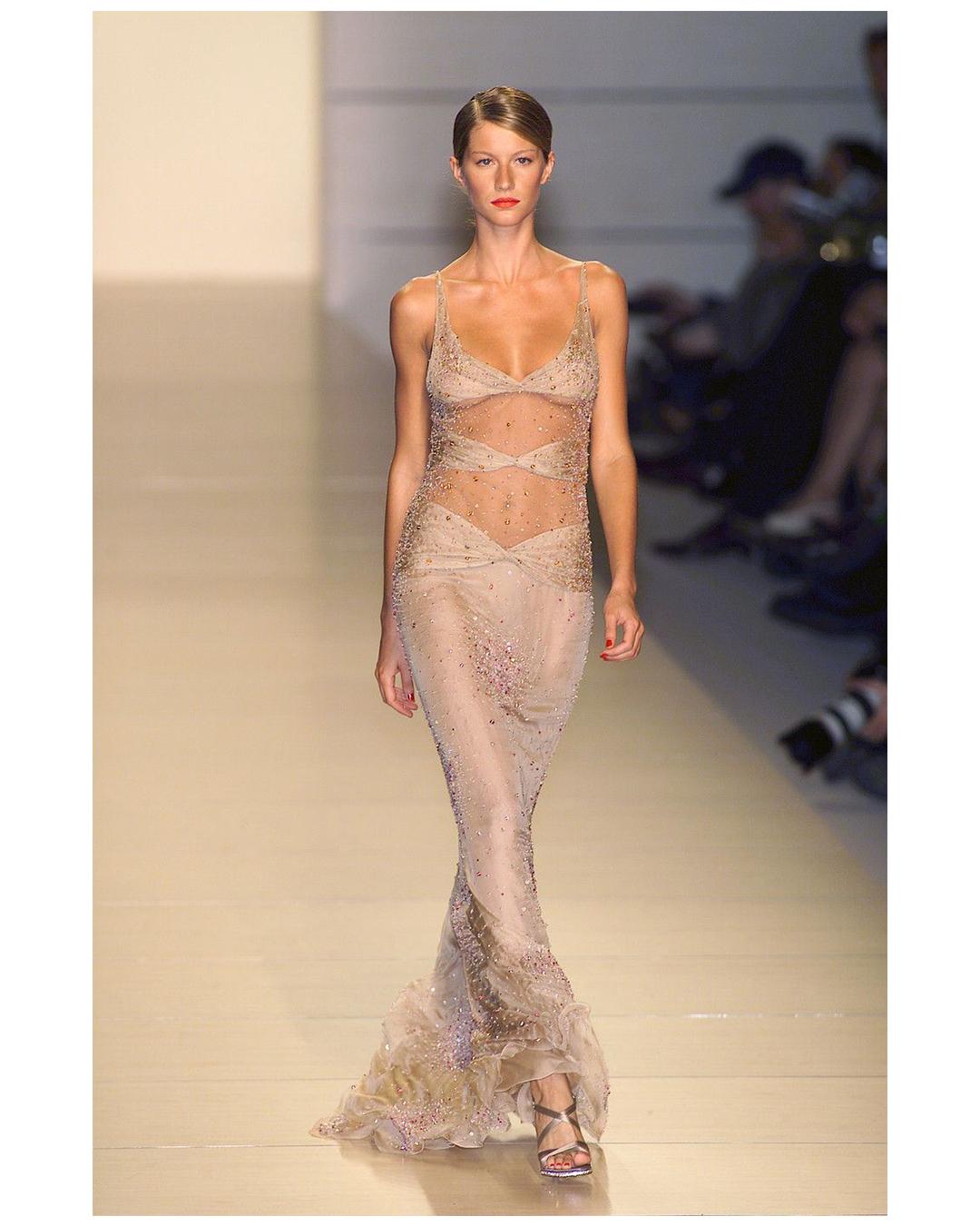 A very rare Vintage Valentino floor length gown from their Spring Summer 2001 Collection (Look 81)
Please note that the commercial version of this dress was made without the ruffles to the hem and with less sheer cut outs than the runway version. I