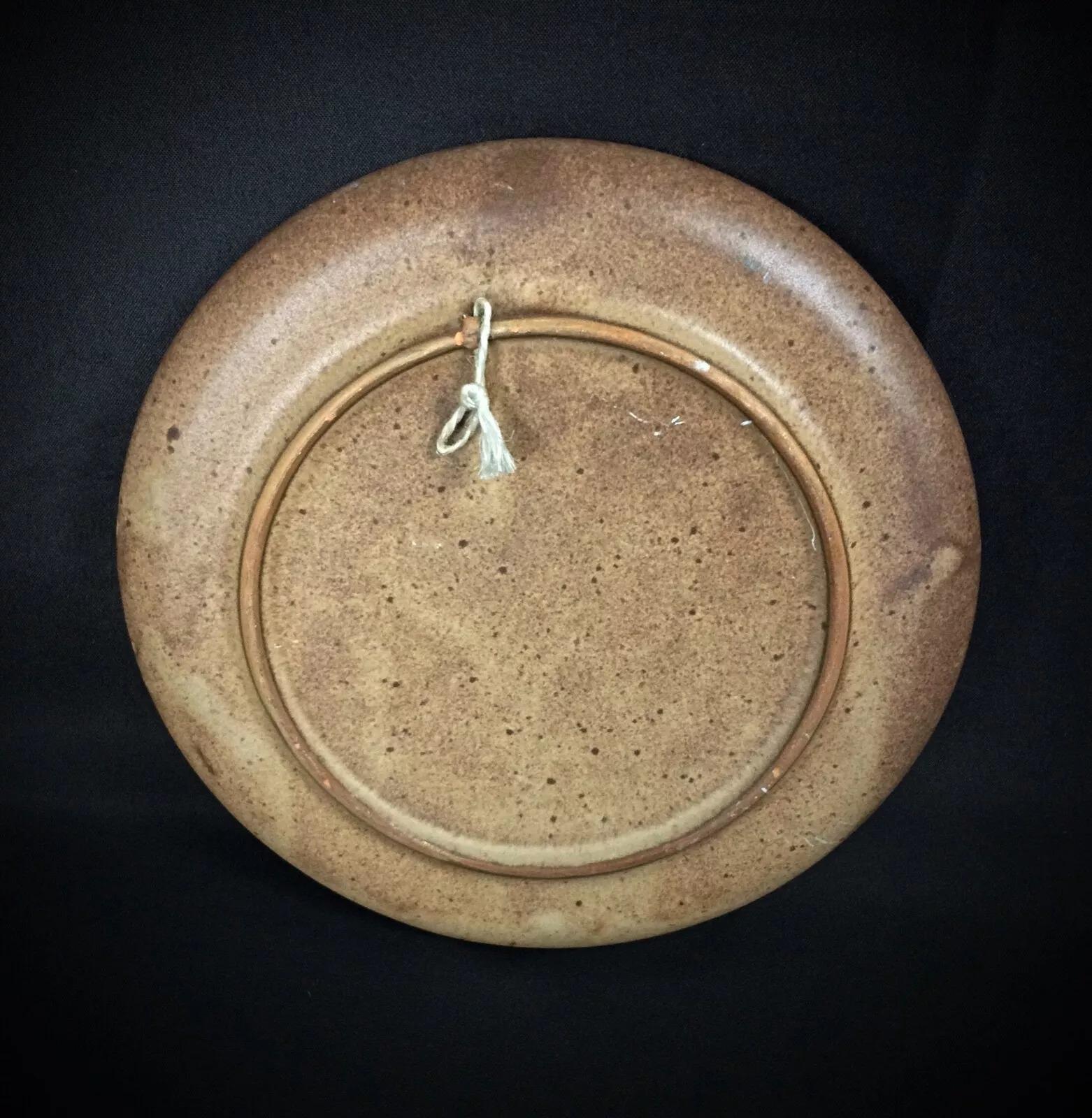 This unique ceramic plate from Vallauris showcases a detailed bas-relief of a weaver, capturing the essence of fine craftsmanship and artistic tradition. A perfect addition for collectors of Vallauris ceramics or lovers of artisanal
