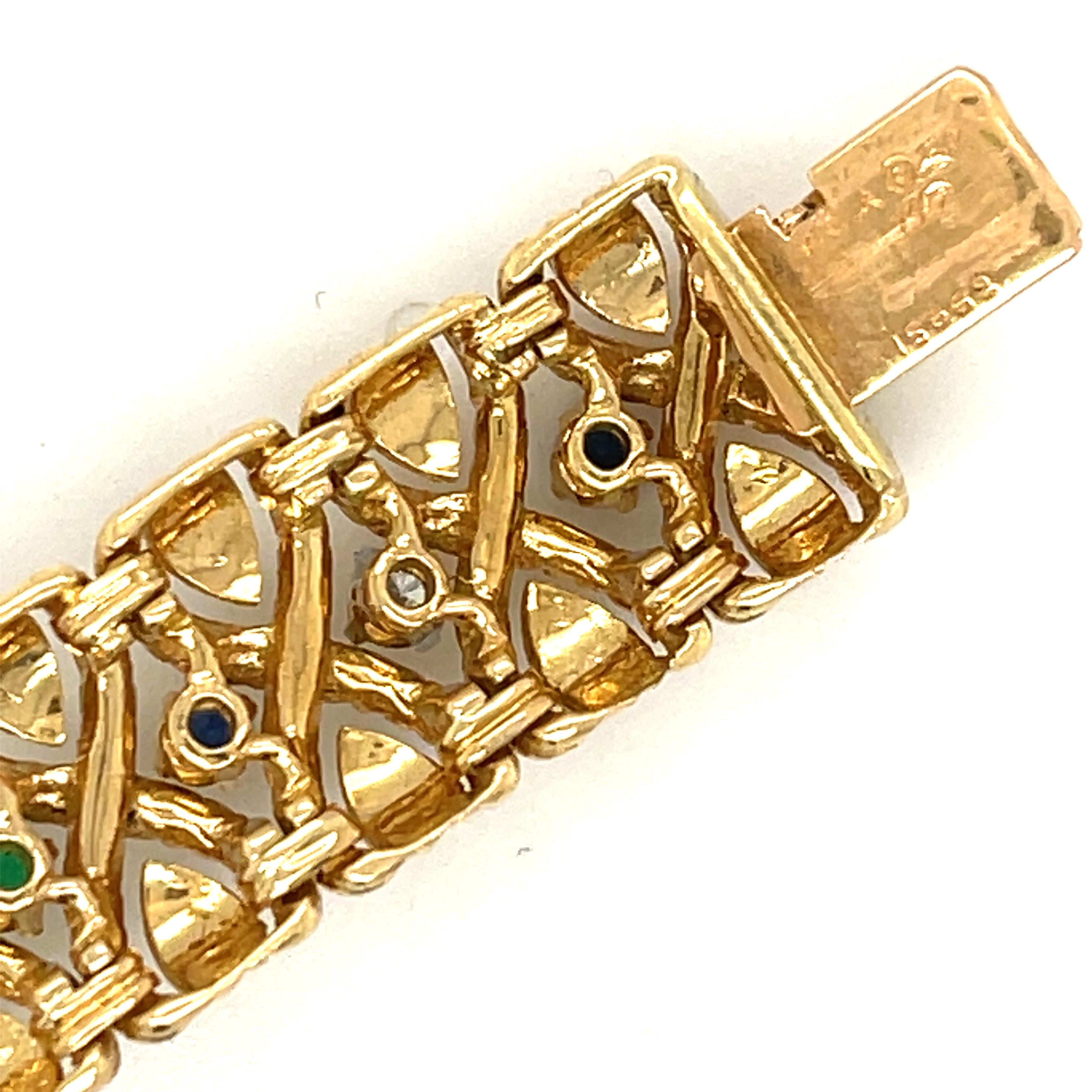 Vintage twisted 18k gold bracelet set with emeralds, sapphires and diamonds by Van Cleef & Arpels, circa 1970. The bracelet has 17 colored gems and 6 diamonds weighing about 0.60 carats. The bracelet is signed VCA 750 with serial numbers and French