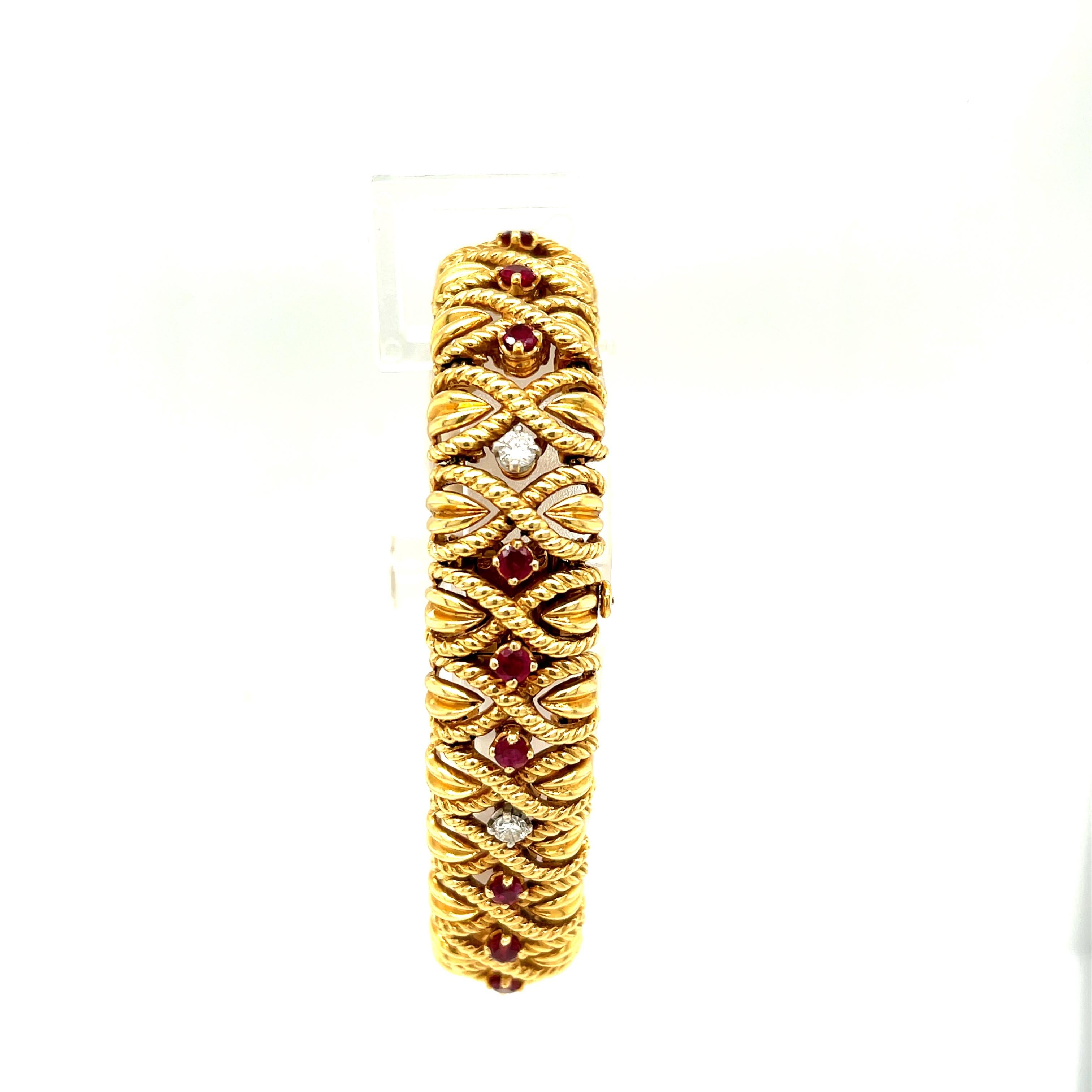 Vintage twisted 18k gold bracelet set with rubies and diamonds by Van Cleef & Arpels, circa 1970. The bracelet has 17 rubies and 6 diamonds weighing about 0.60 carats. The bracelet is signed VCA 750 with serial numbers and French makers mark and