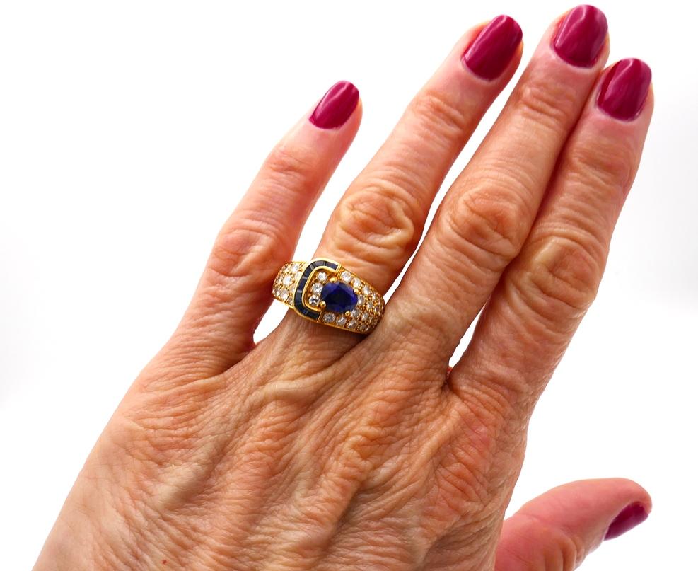 Fun yet classy buckle ring created by Van Cleef & Arpels in France in the 1970s. 
Made of 18 karat yellow gold and set with finest sapphires and diamonds. The oval sapphire weighs approximately 1.33 carat, the diamonds are round brilliant cut, F-G