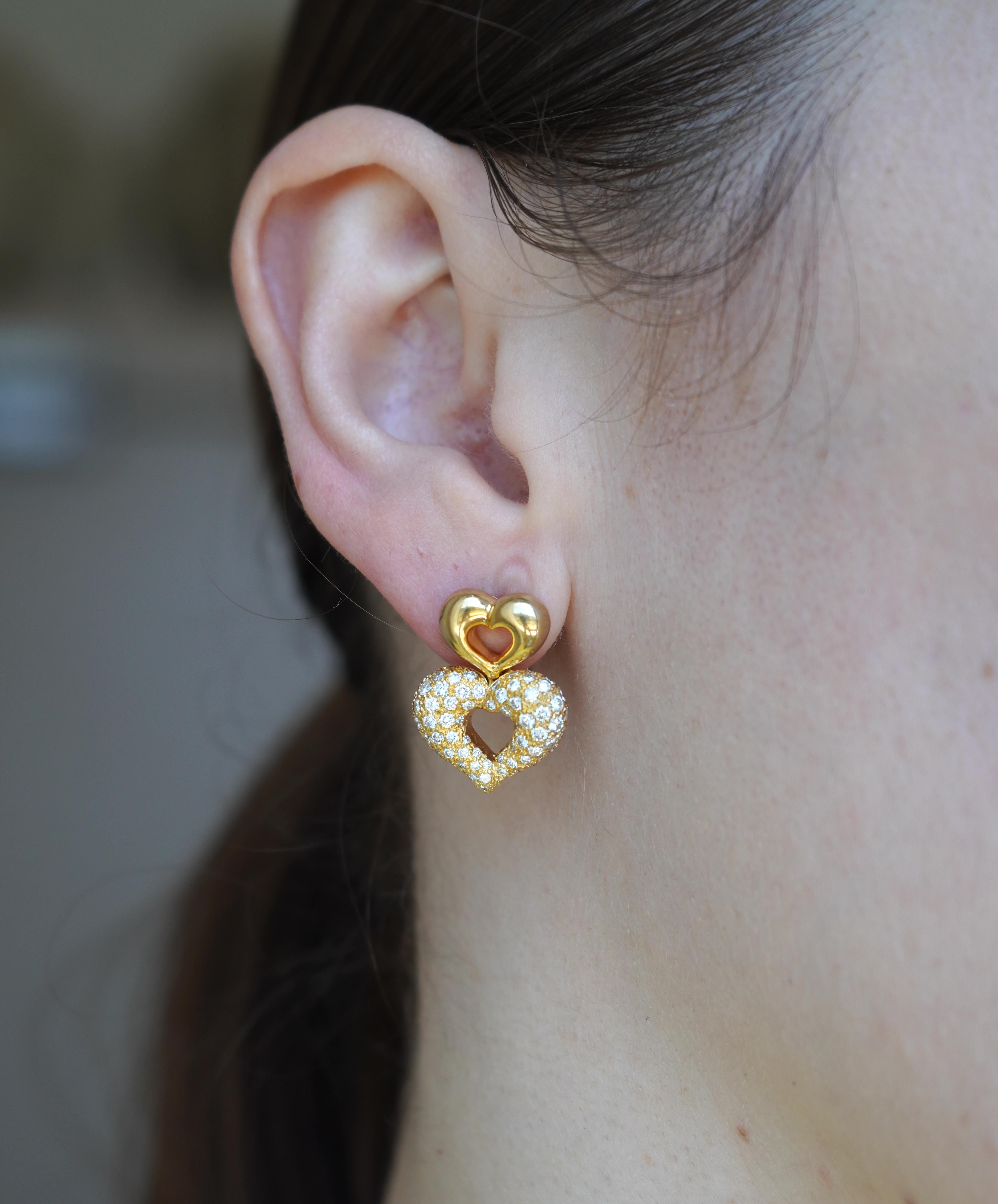 Diese romantischen und ikonischen Ohrringe von Van Cleef & Arpels in Herzform sind aus 18 Karat Gelbgold gefertigt und mit Diamanten im Brillantschliff in einer Pavé-Anordnung besetzt. Das Doppelherzmotiv ist durchbrochen und besteht aus einem
