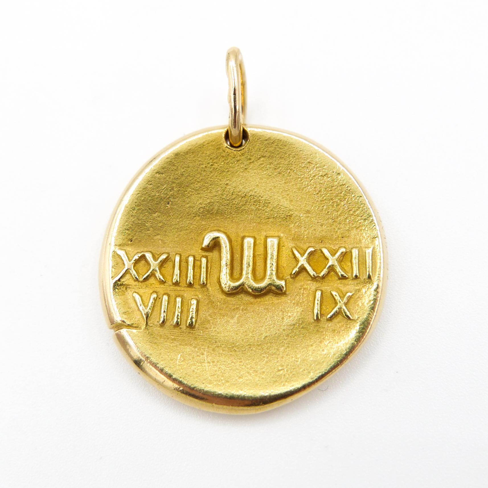 Vintage Van Cleef & Arpels Virgo zodiac medallion pendant in 18k yellow gold, designed to resemble an ancient coin, depicting a unicorn beside a standing woman on the front and Roman numerals with symbol for the sign on the back, circa 1950's/1970's