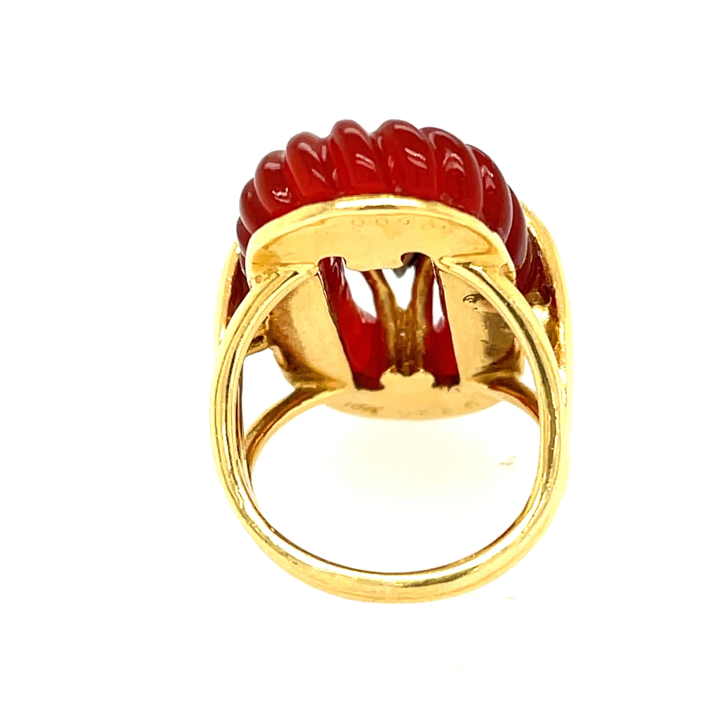 A vintage 18k yellow gold pave diamond and fluted carnelian cocktail ring by Van Cleef & Arpels, circa 1970. This colorful oval shaped ring features an oval of fluted carnelian set with diamonds in the center. There are 16 round brilliant diamonds