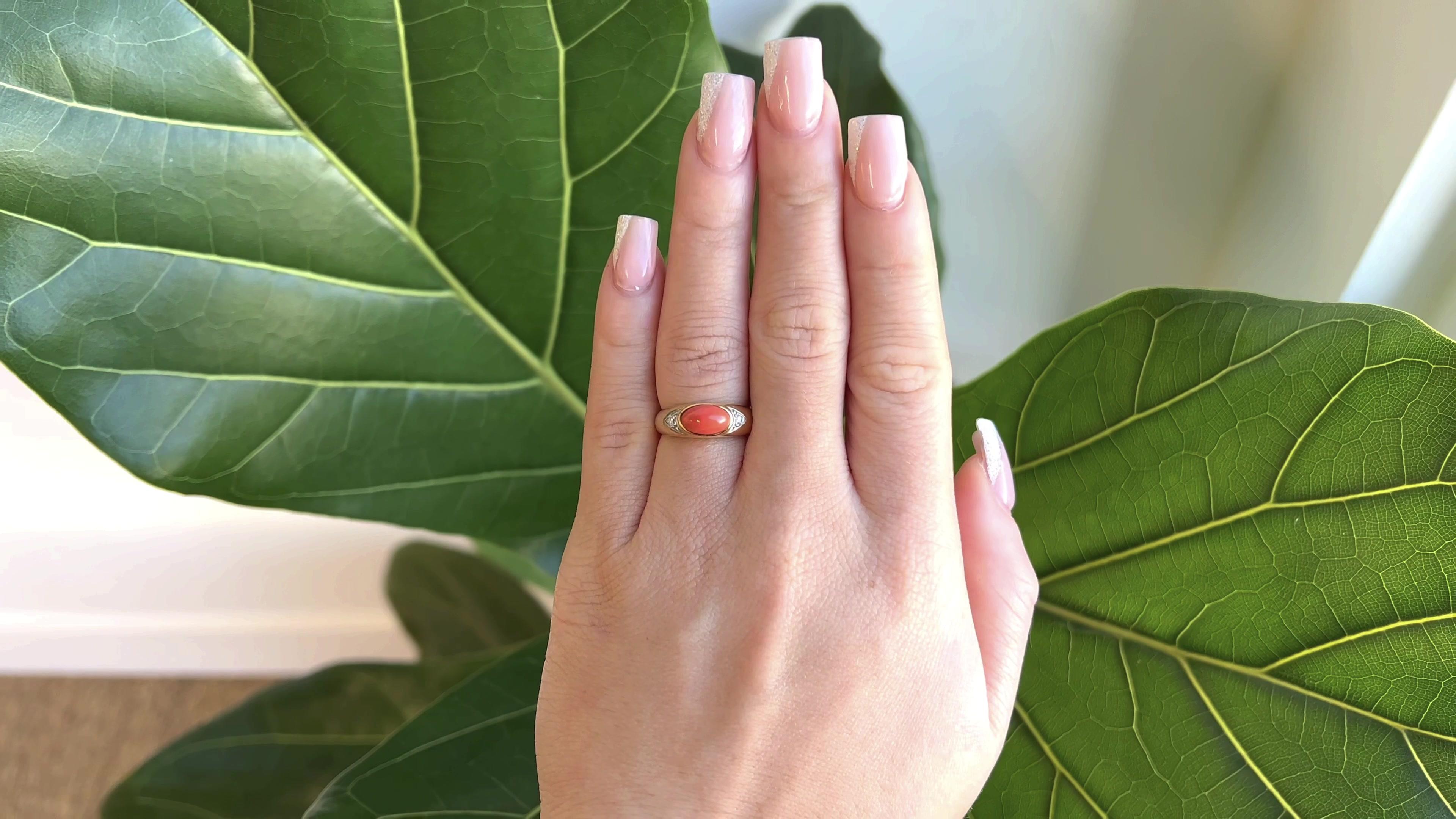 One Vintage Van Cleef & Arpels Coral Diamond 18 Karat Gold Ring. Featuring one cabochon cut coral of approximately 1.90 carats. Accented by two round brilliant cut diamonds graded D-E color, VVS clarity. Crafted in 18 karat yellow gold with diamonds
