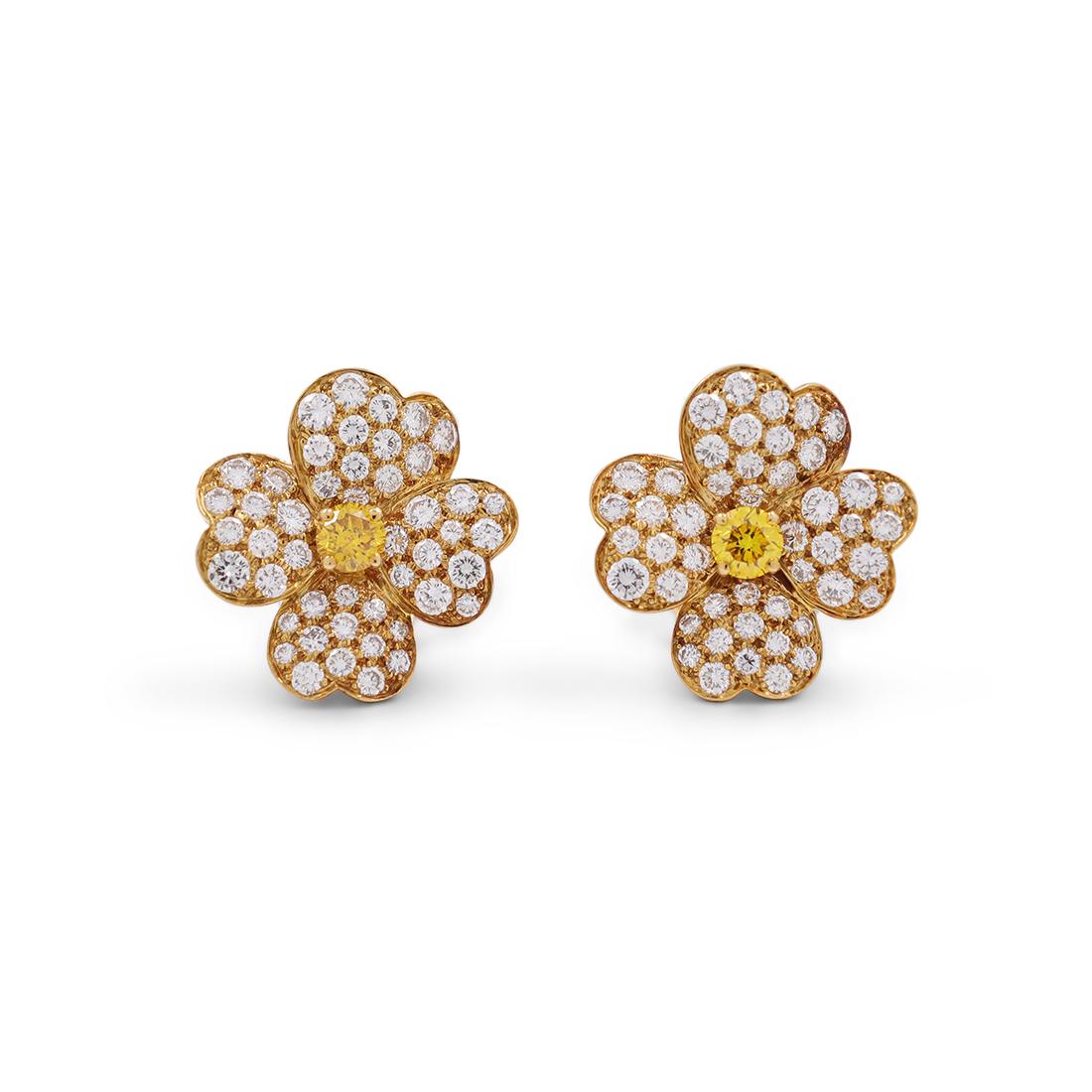 Authentic Van Cleef & Arpels 'Cosmos' earrings crafted in 18 karat yellow gold.  Each earring's four heart-shaped petals are set with round brilliant cut diamonds weighing an estimated 2.80 carats for the pair.  The center of each earring is