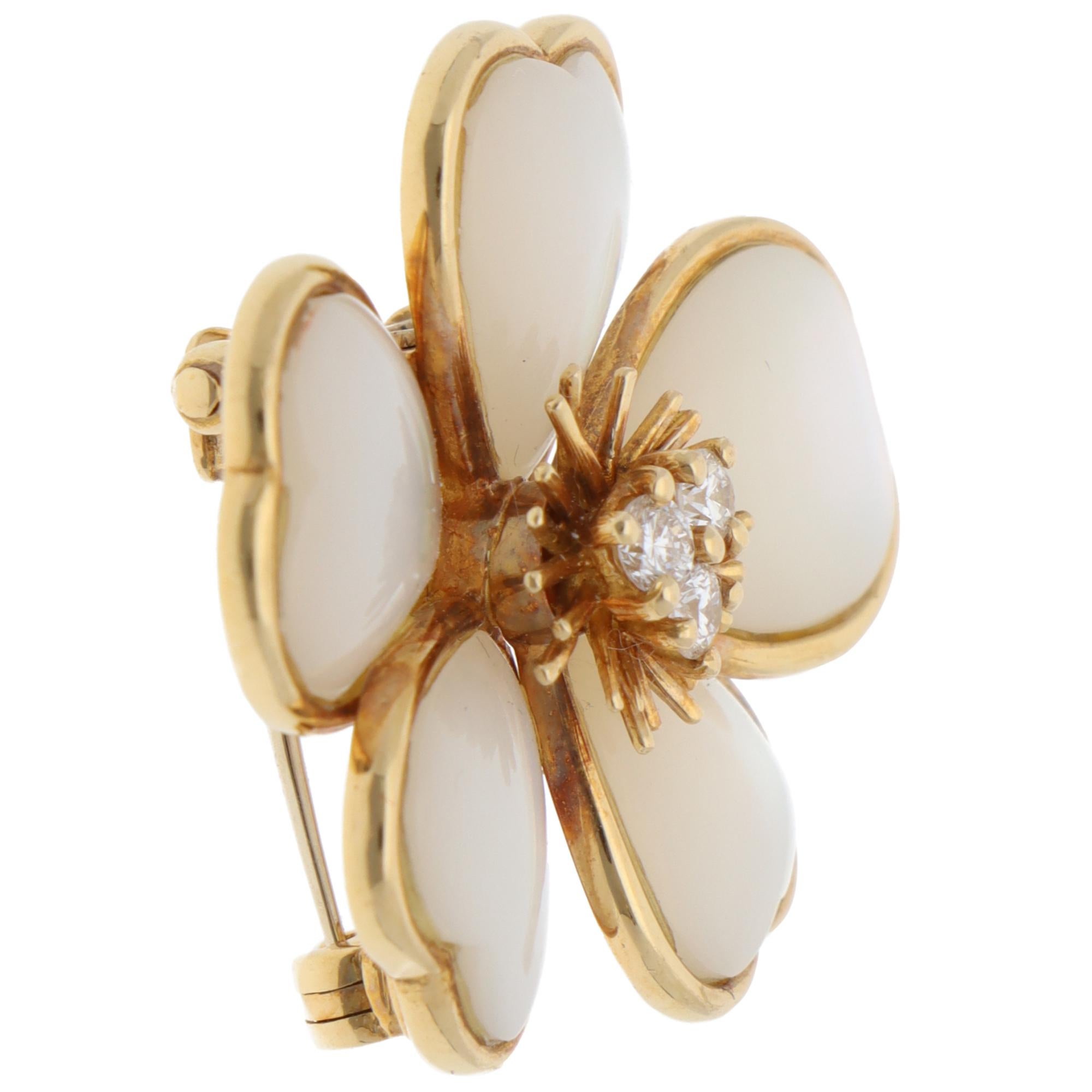 A beautiful vintage Van Cleef & Arpels mother-of-pearl and diamond floral brooch set in 18k yellow gold.

From Van Cleef & Arpels's discontinued collection, the brooch depicts a flower motif. The cabochon mother-of-pearl is bezel-set in polished