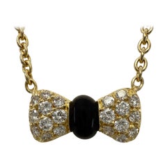 Vintage Van Cleef & Arpels Onyx Diamond 18k Yellow Gold Ribbon Pendant Necklace Vintage Van Cleef & Arpels Onyx Diamond 18k Yellow Gold Ribbon Pendant Necklace