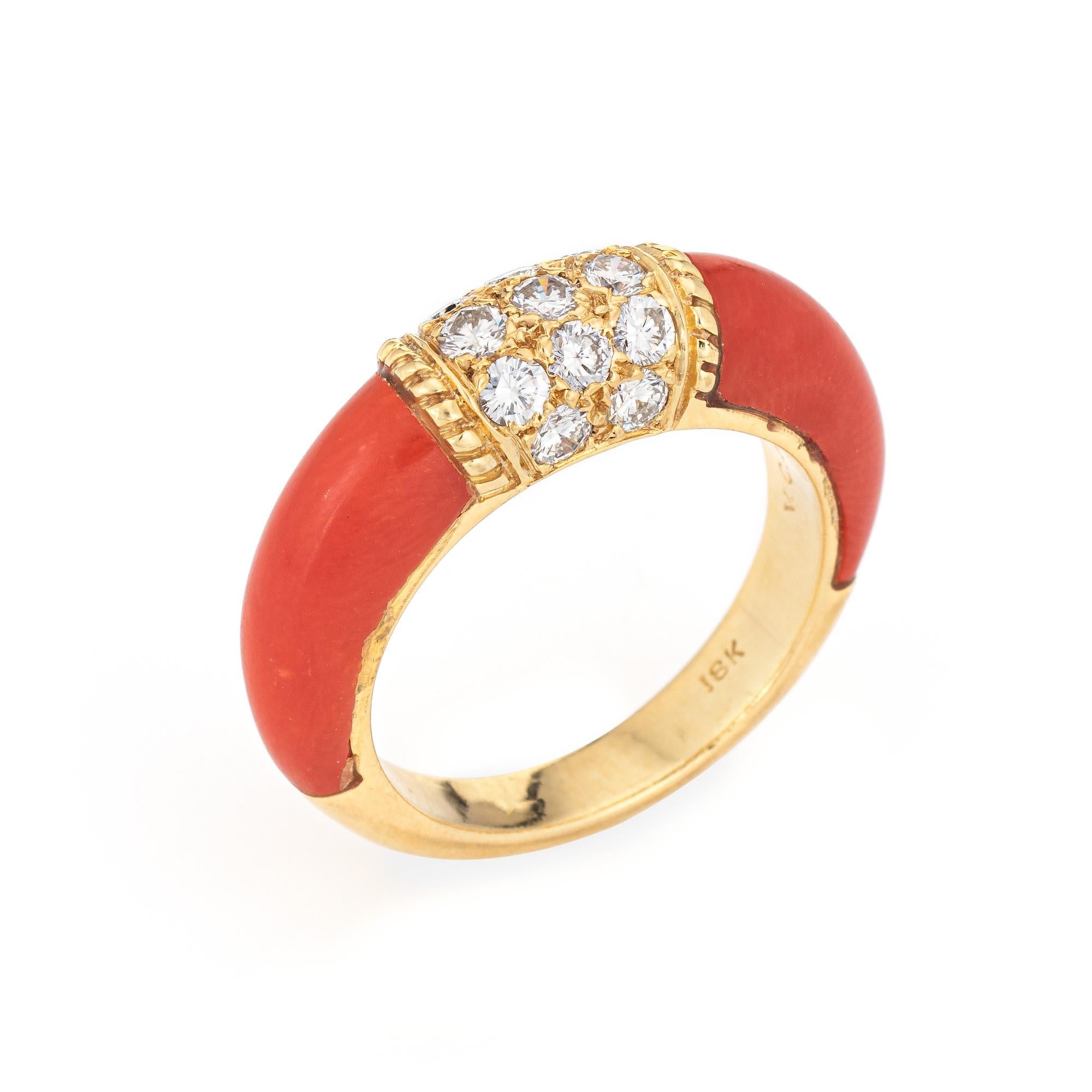 Stylish vintage Van Cleef & Arpels coral & diamond ring crafted in 18 karat yellow gold. 

13 round brilliant cut diamonds total an estimated 0.65 carats (estimated at F-G color and VVS2 clarity). Coral is inlaid into the side shoulders and measures