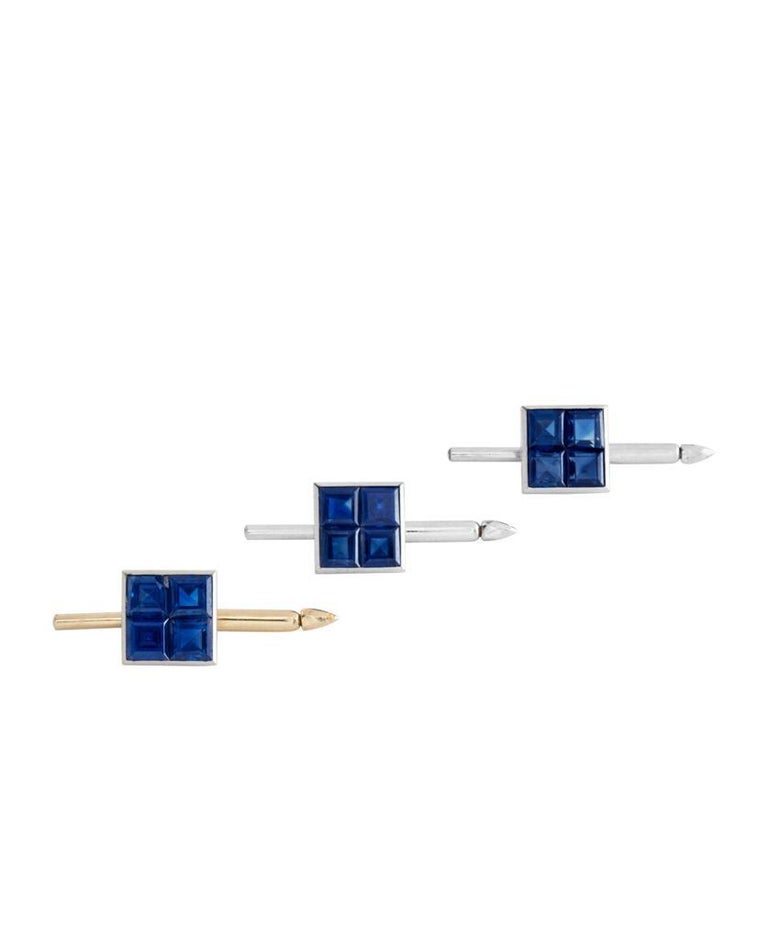 An exceptional and extremely rare set of vintage Van Cleef & Arpels Mystery-Set cufflinks and dress-set, made in platinum and gold. The buttons and cufflinks are articulately set with vibrant blue square-cut sapphires. The collection is engraved and