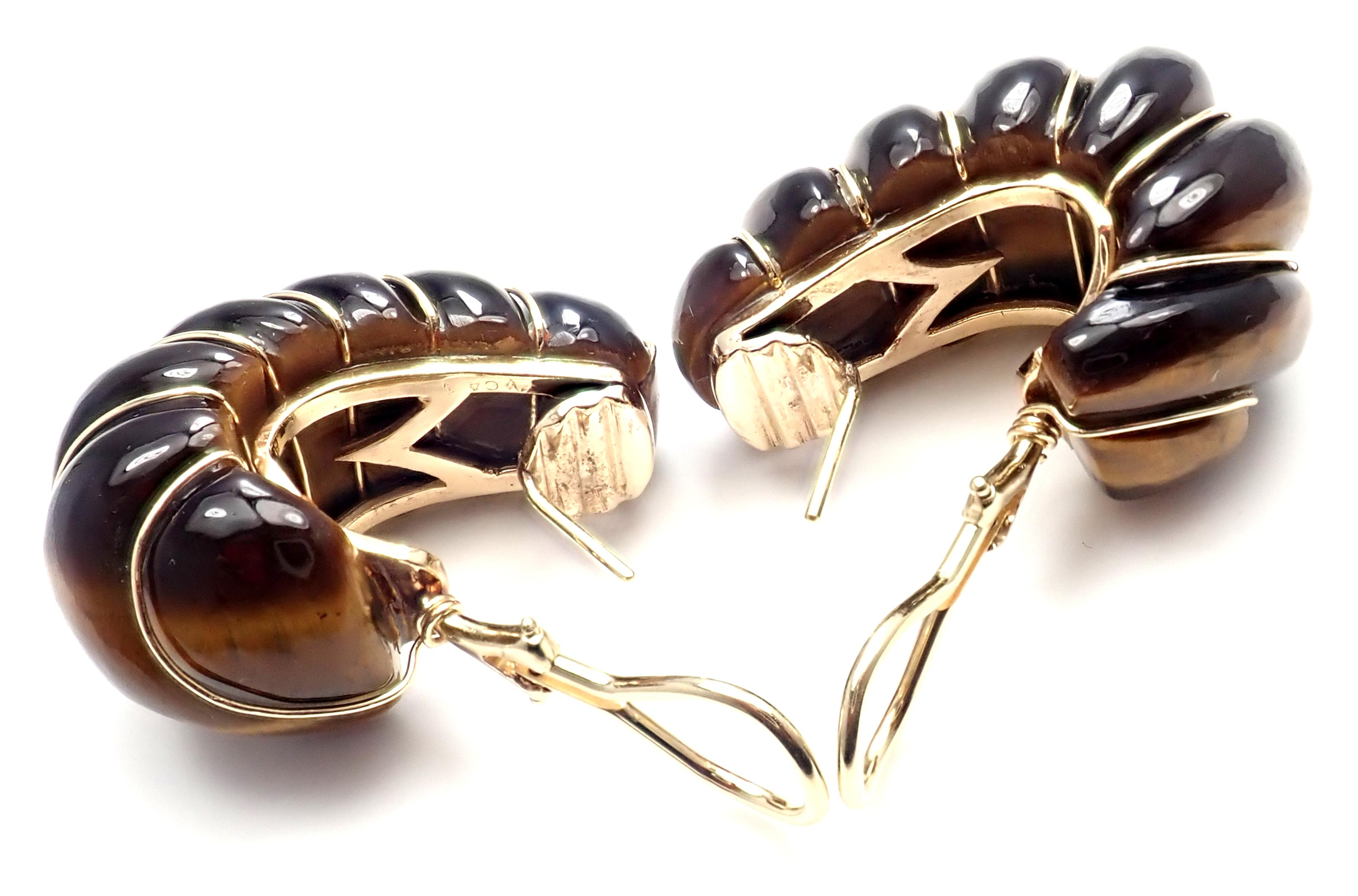 18k Yellow Gold Tiger's Eye Vintage Hoop Earrings by Van Cleef & Arpels.
With 2 carved tiger eye stones.
Details:
Weight: 33 grams
Measurements: 33mm x 17mm
Stamped Hallmarks: VCA 3V883.7 
*Free Shipping within the United States*
YOUR PRICE: