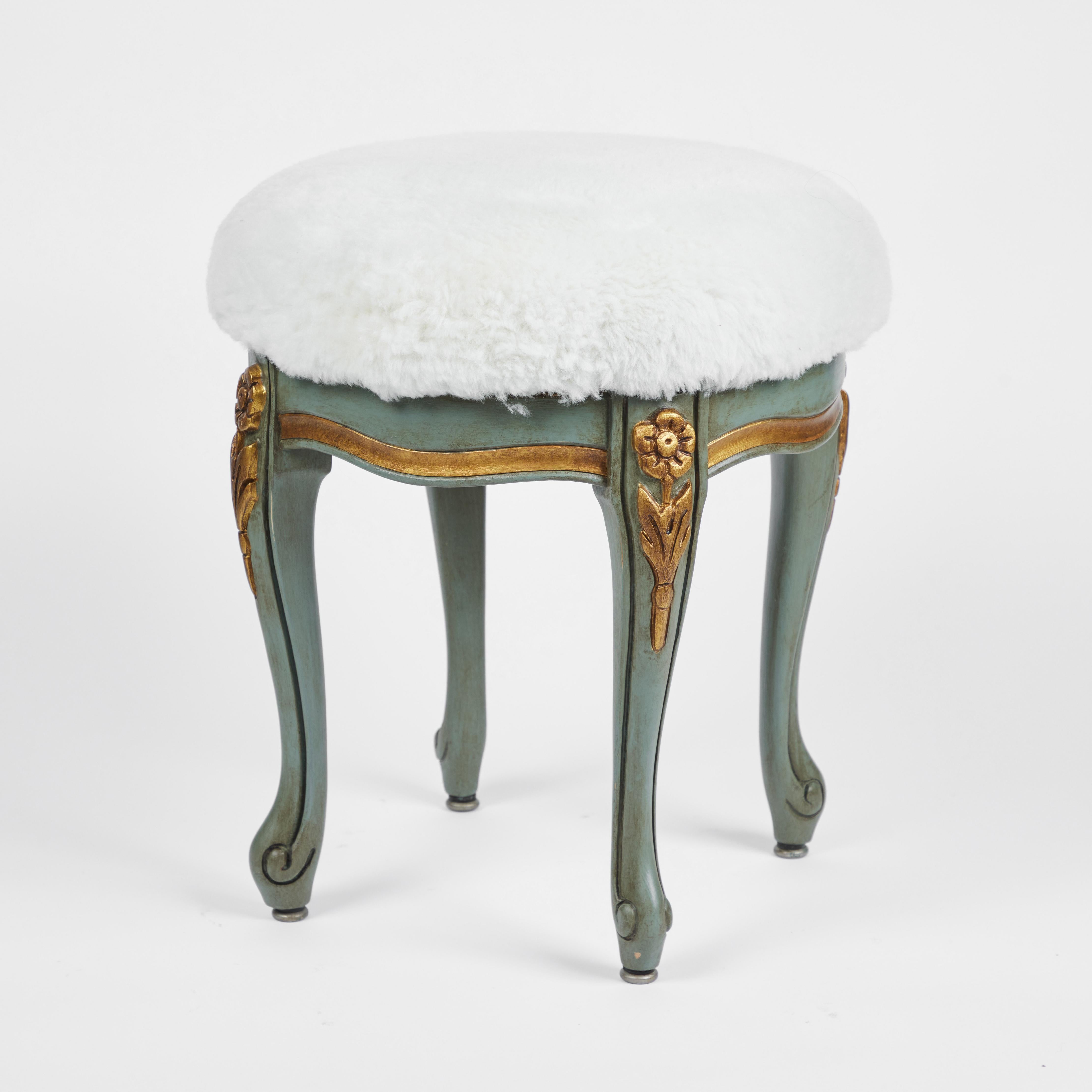 This is the perfect little vintage vanity stool.
It has been newly painted in the 'Swedish' style in aqua and gold paint with an antiqued finish, newly upholstered in fluffy white shearling and is that splendid touch of lovely with its decorative