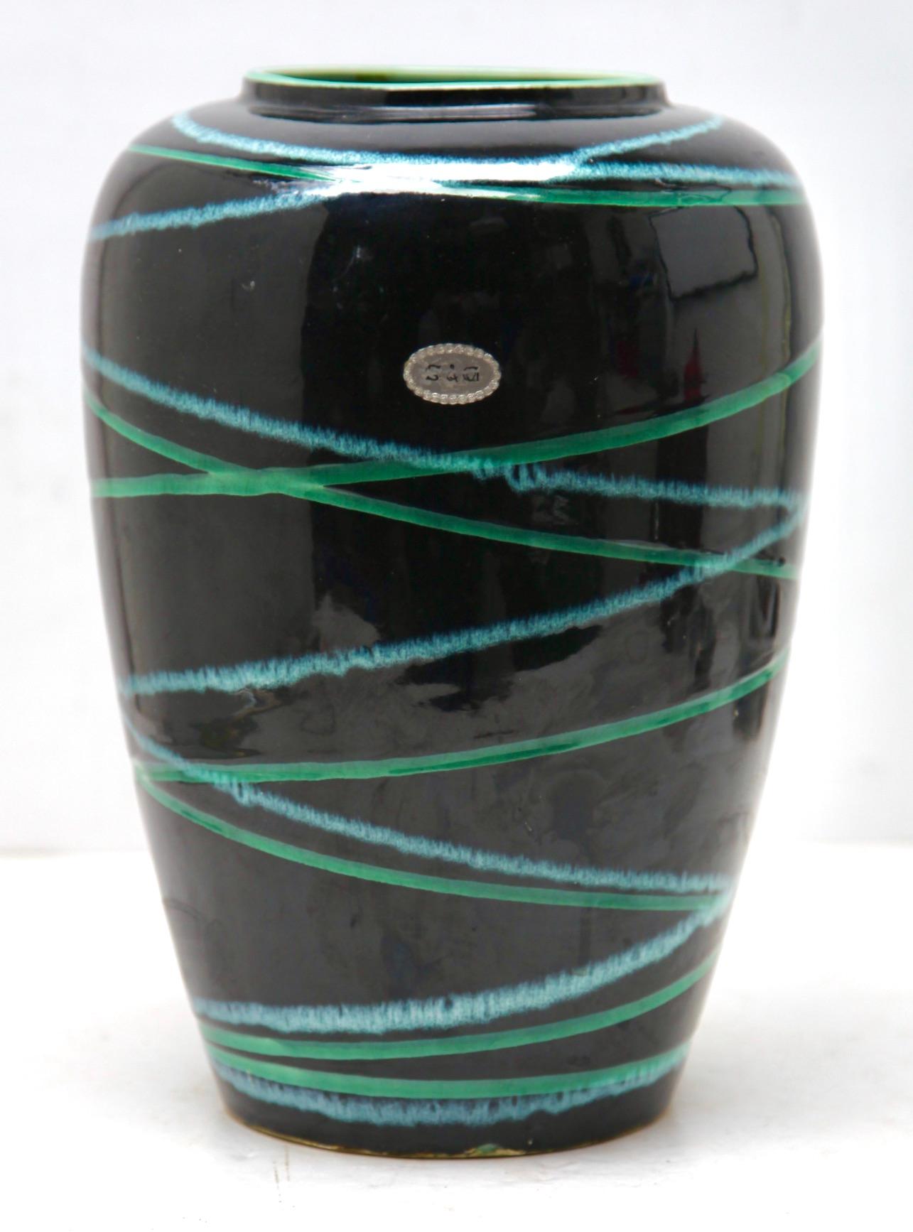 Questo vaso vintage originale è stato prodotto negli anni '1970 in Germania. È realizzato in ceramica.
Sul fondo è riportato il numero di serie del vaso Foreign 239-30 Handarbeit.
Design lineare e minimalista dell'era del design degli anni '1960.