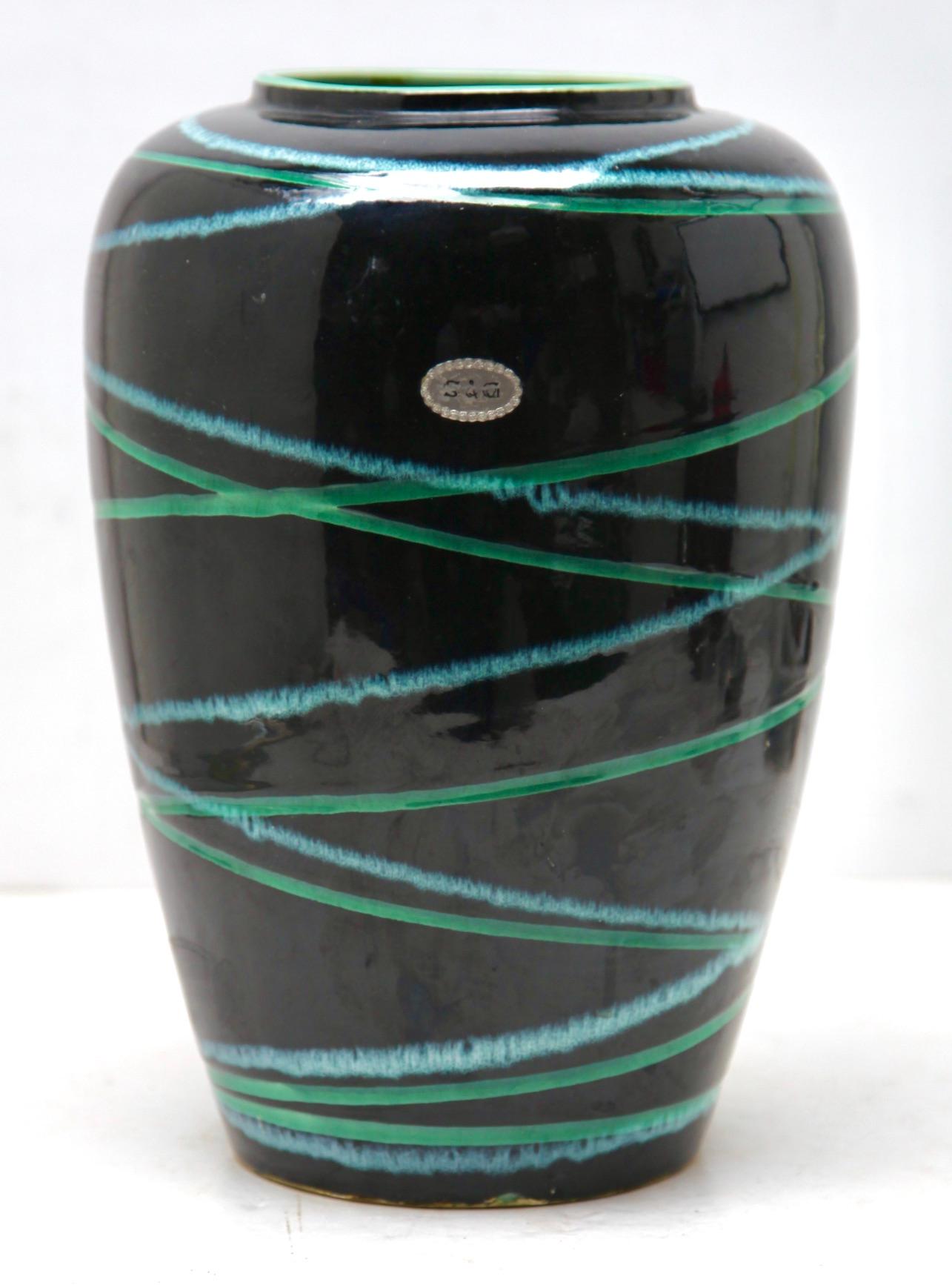 These original vintage vase was produced in the 1970s in Germany. It is made of ceramic pottery.
The bottom are marked the vase Foreign series number 239-30 Handarbeit.
Straight forward and minimalistic design of the 1960s design era. 
Super rare