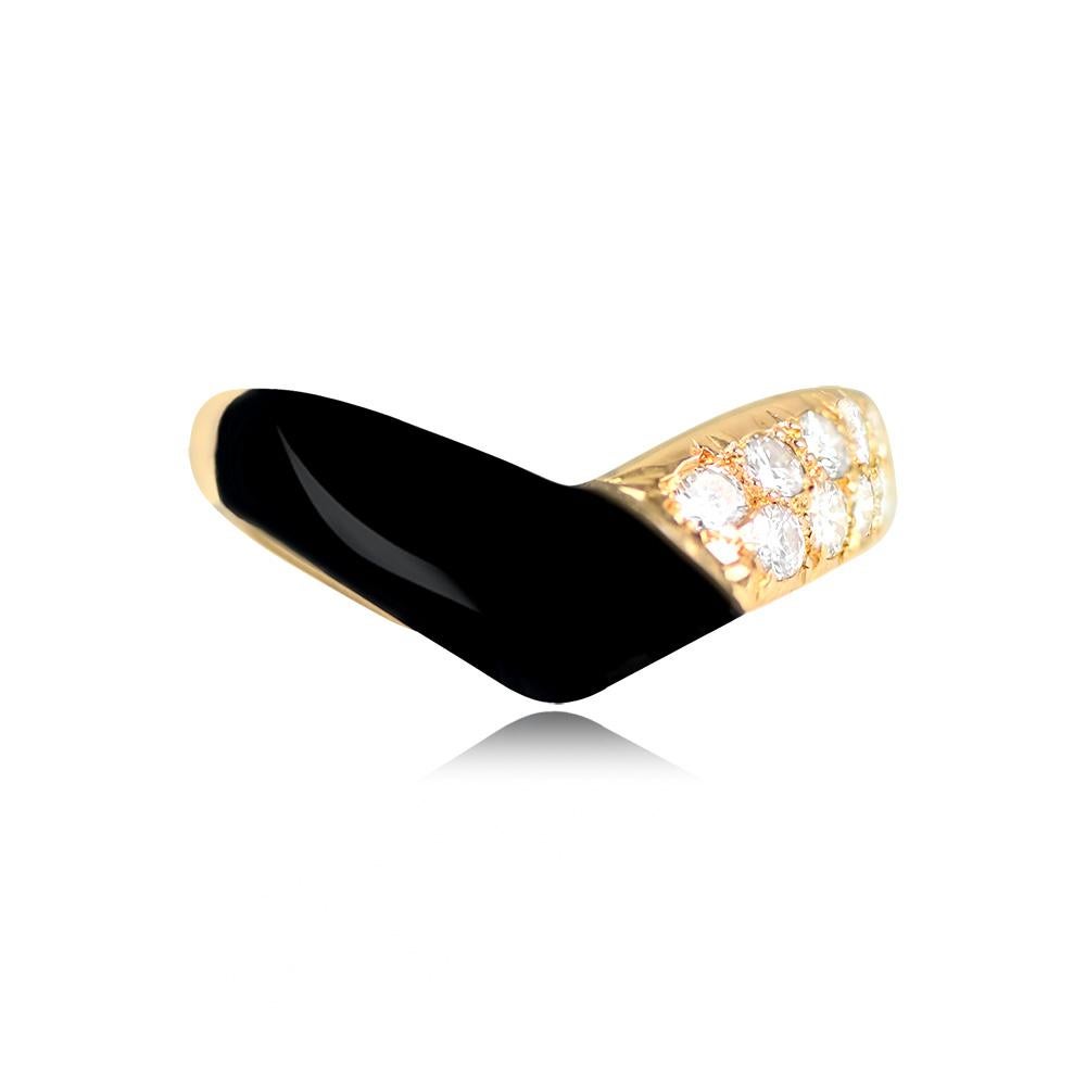 A captivating vintage VCA ring showcasing a striking combination of onyx and pave-set round brilliant-cut diamonds arranged in a V-shaped design. The diamonds have an approximate total weight of 0.52 carats, adding sparkle and allure to the piece.