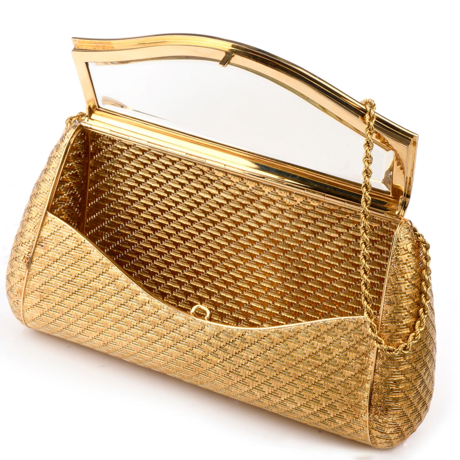 This exquisite Vintage Italian 1960's Clutch Purse was inspired with a soft textured 18k rope chain strap. Elegantly pattern with a hidden mirror in the interior and crafted in 408.6 grams of 18K yellow gold.  
Measures approximately 4in tall x 7in