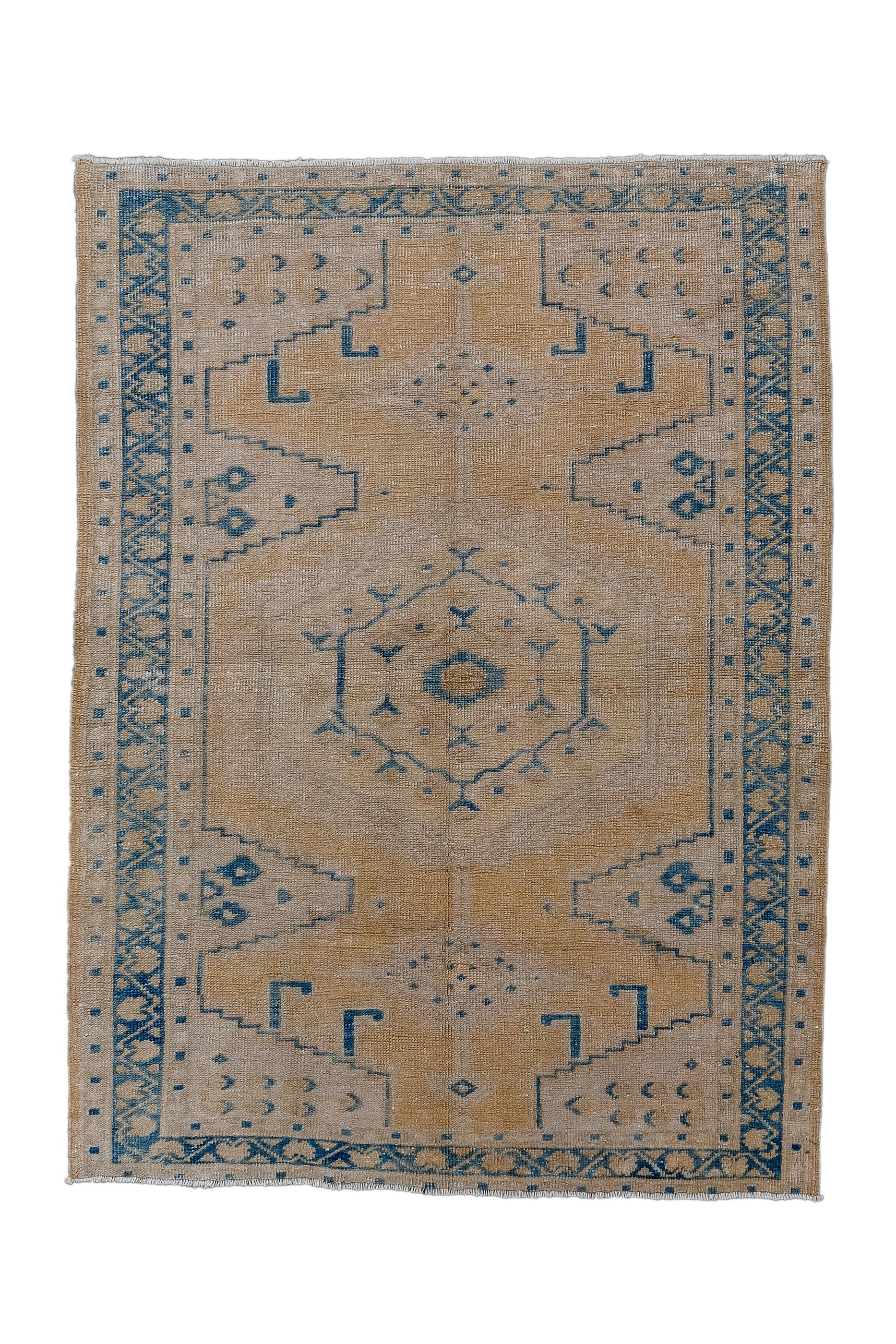 This scatter shows many of the defining characteristics of the better-known large carpets from the area, including boldly hooked corners, half lateral lozenges, an hexagonal medallion, all on the pumpkin semi-open field.  Main border of reversing