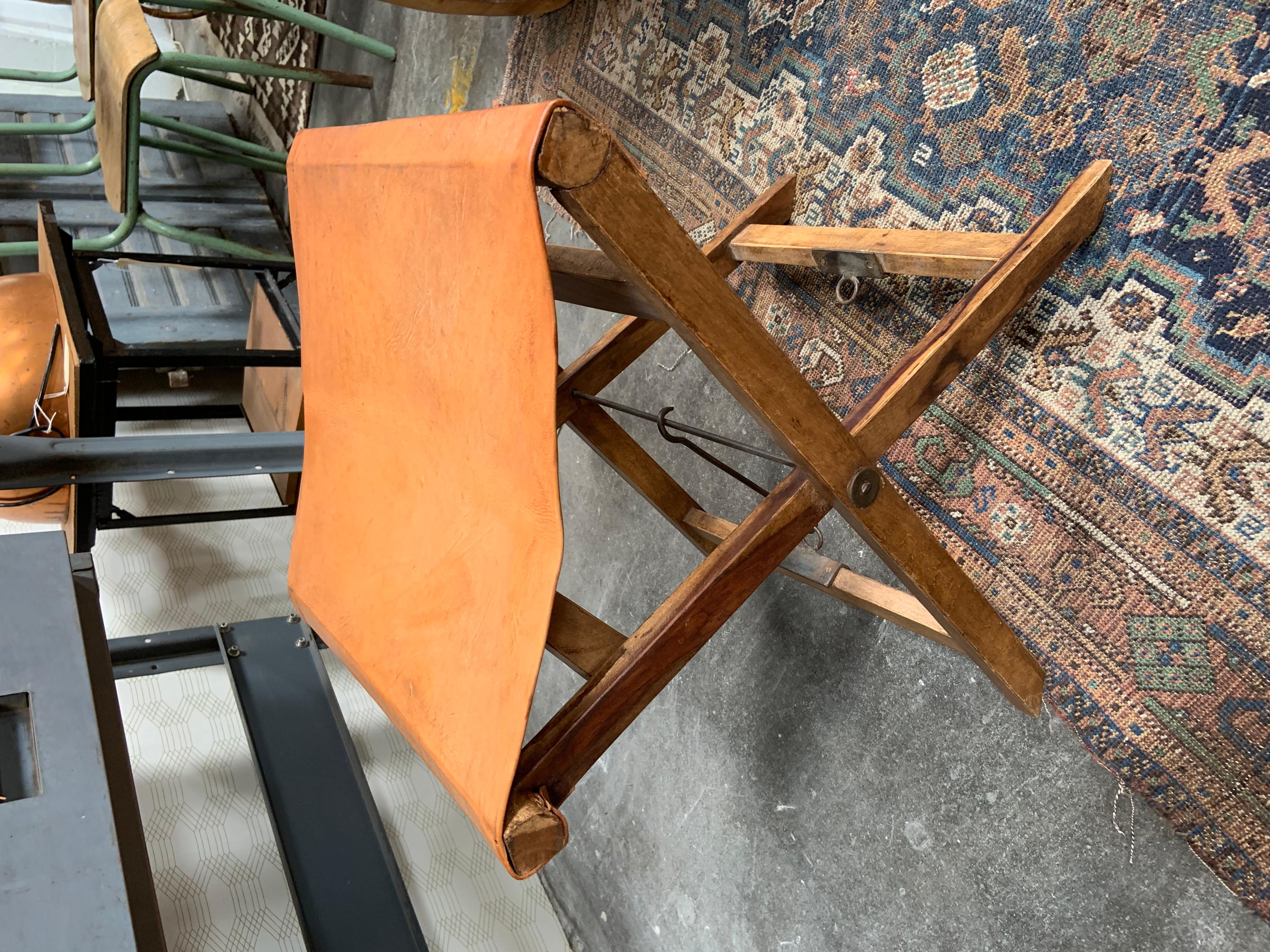 This folding leather and wood sling chair is multipurpose, making a perfect camp stool or even a plant stand. The gorgeous vegetable tan leather pairs perfectly with the rustic wood legs and aged metal hardware.
Measures: 16.5