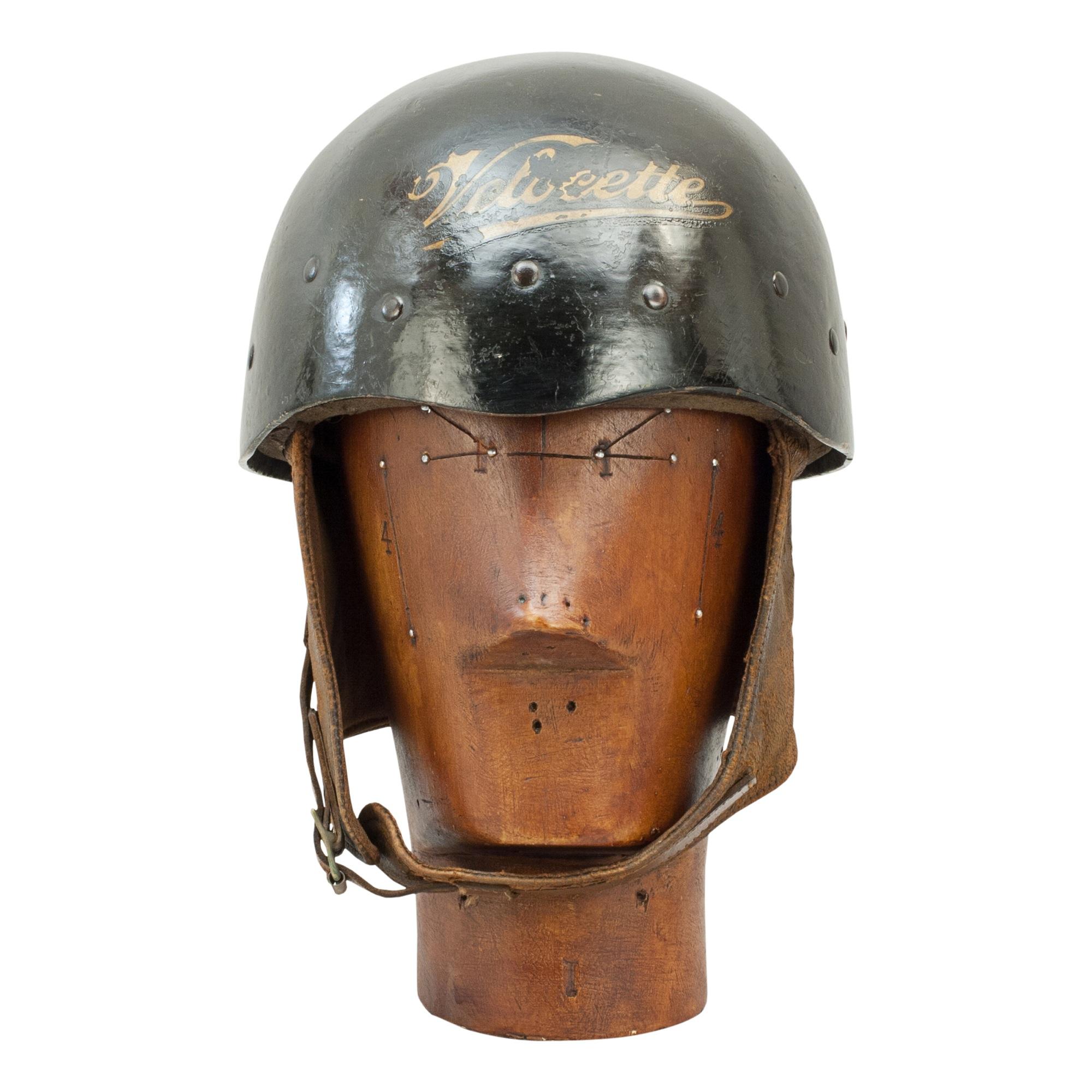 Vintage Velocette motorcycle crash helmet.

A 'Centurion' pudding basin style motorcycle helmet, The Patent Pulp model. The helmet is painted black with a Velocette transfer to front. This helmet fitted with a leather headband and webbing straps