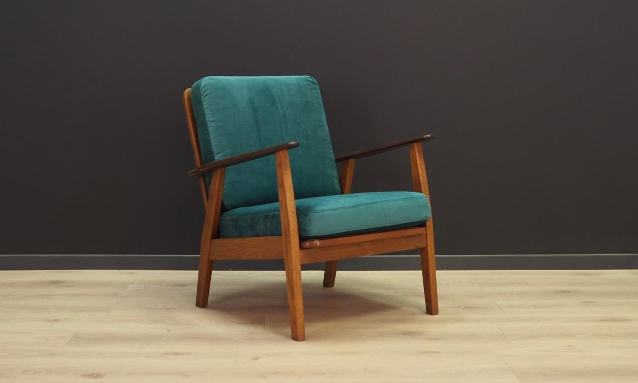 Fantastic armchair from the 1960s-1970s, Danish design, minimalistic form. Armchair has original upholstery made of velour in green color. Construction made of solid oakwood, armrests made of teak wood. Maintained in good condition (minor bruises