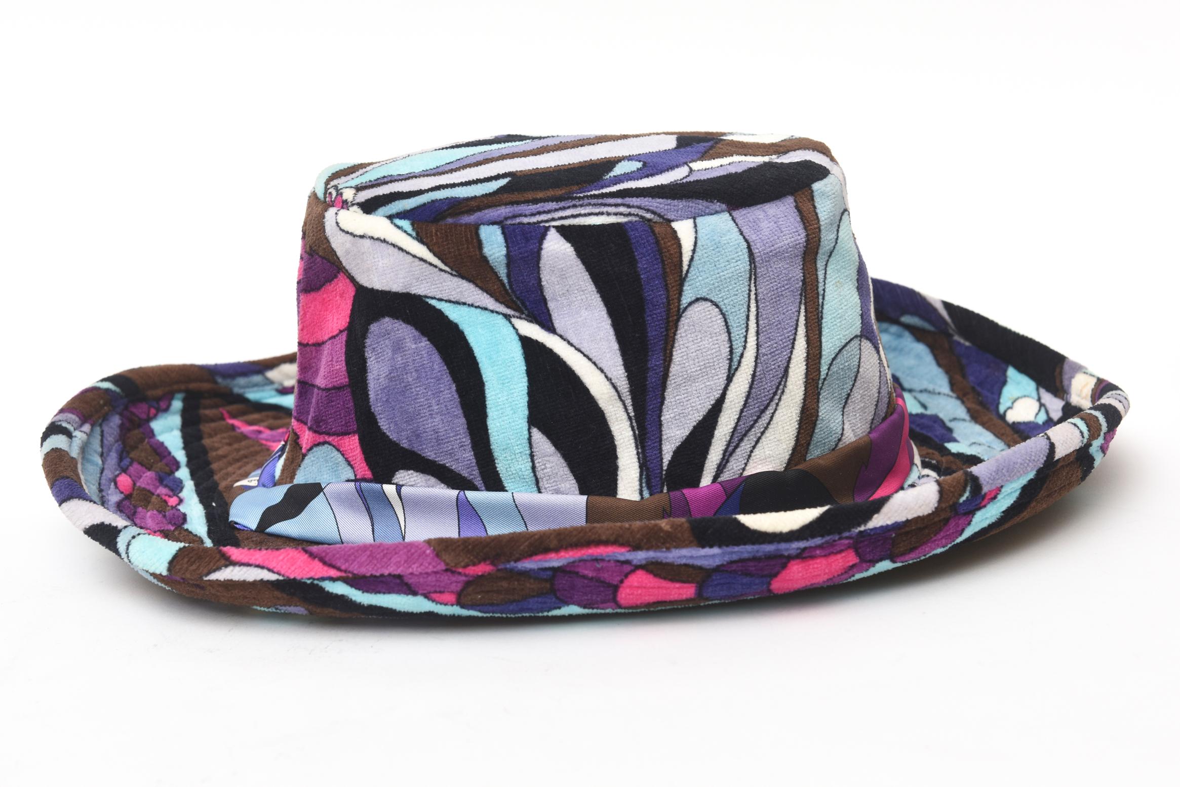 This fabulous vintage Emilio Pucci velvet hat is from the 60's. It has a cowboy style wide brim high center. It is a size small and will fit a very small head. The swirling colors are luscious of hues of brown, black shades of purple and shades of