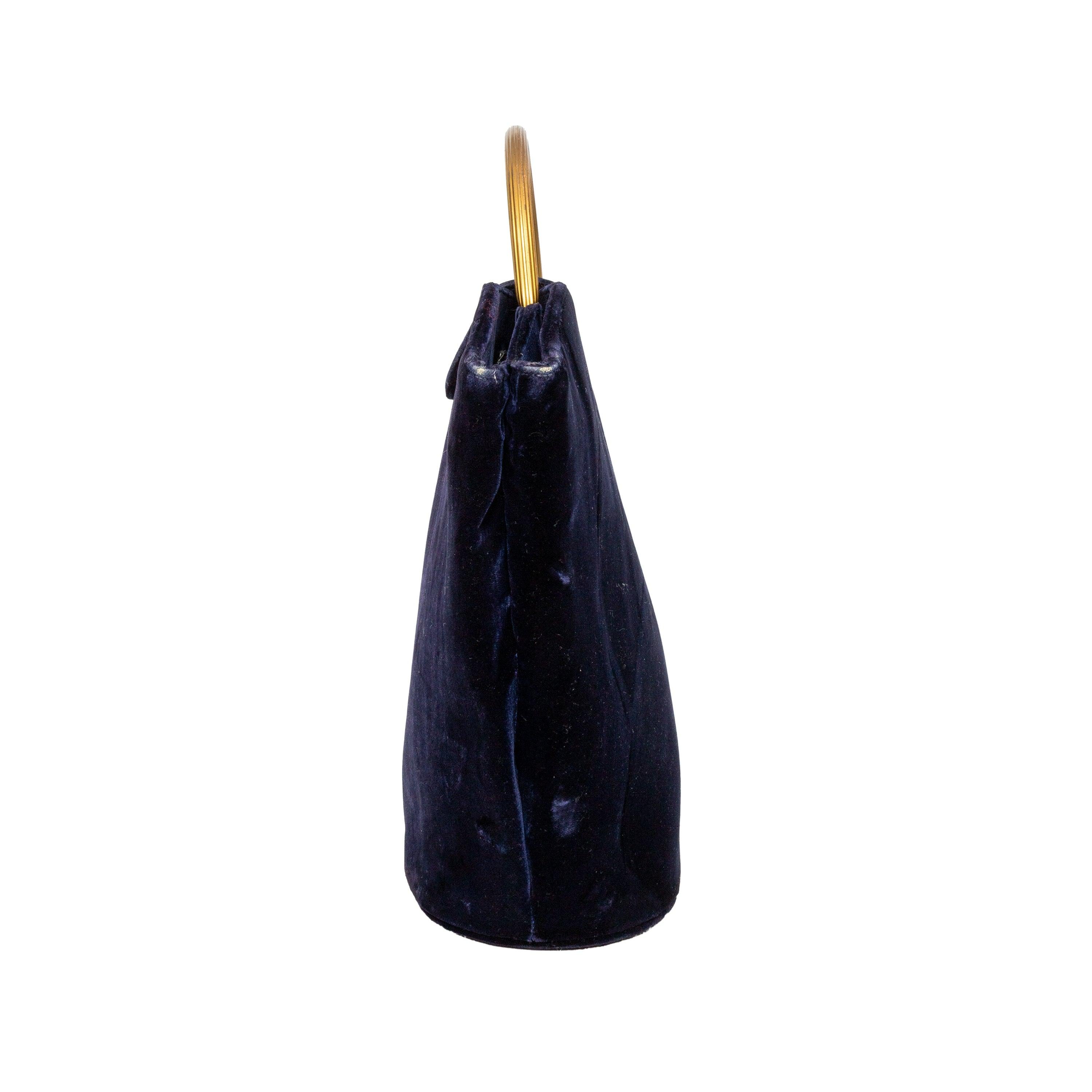 Dark blue velvet handbag with a golden top handle and flap closure, featuring a beautifully shaped design that adds a touch of vintage elegance to any outfit.
 Remarks: Signs of interior wear and some stains. 
 Measurement: