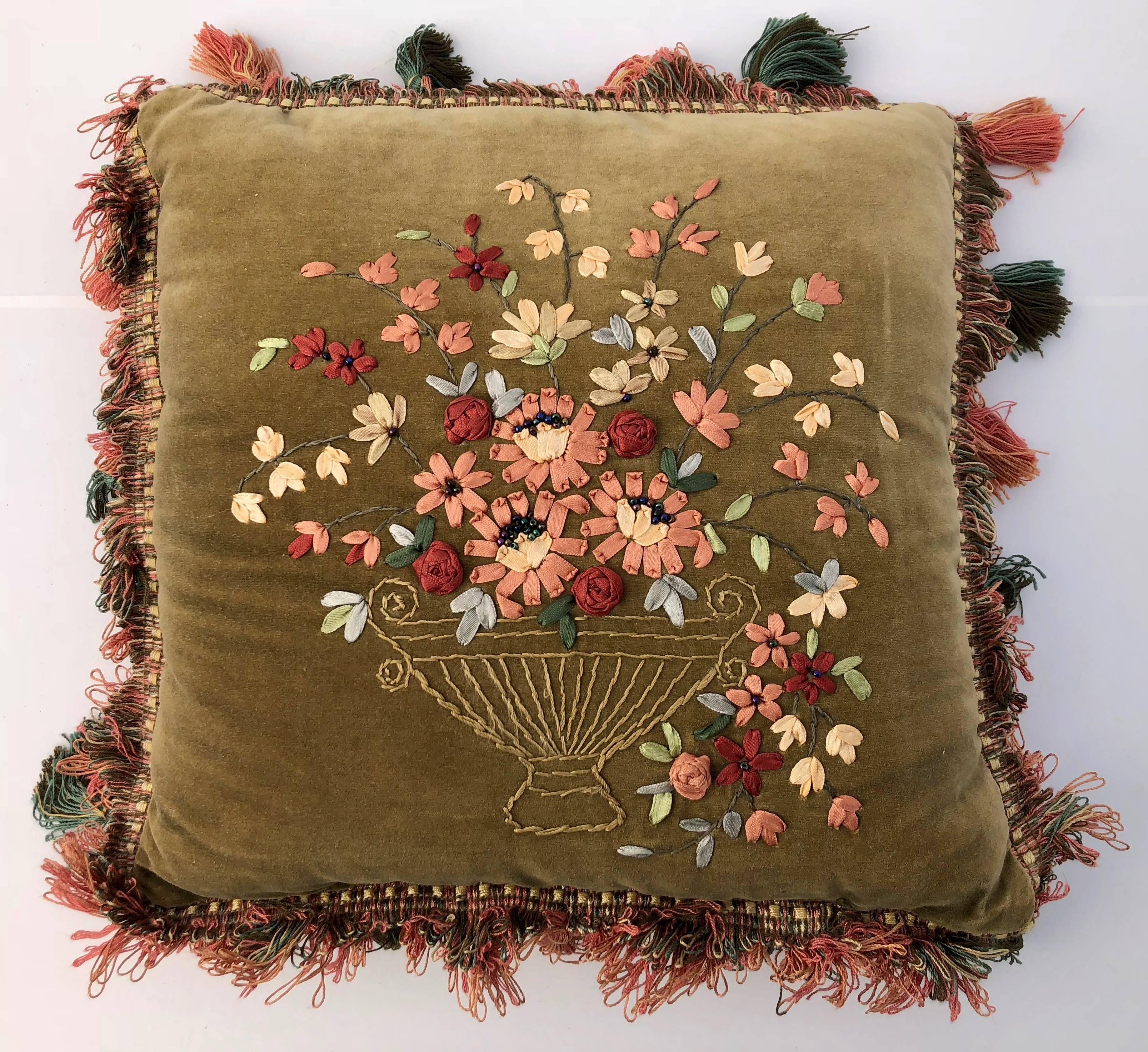 All of these beautiful ribbon art pillows are in velvet. They are in a variety of designs and colors that blend well together. Four of the pillows have tassels on their borders and all are finished with decorative trim. Their colors are lovely and
