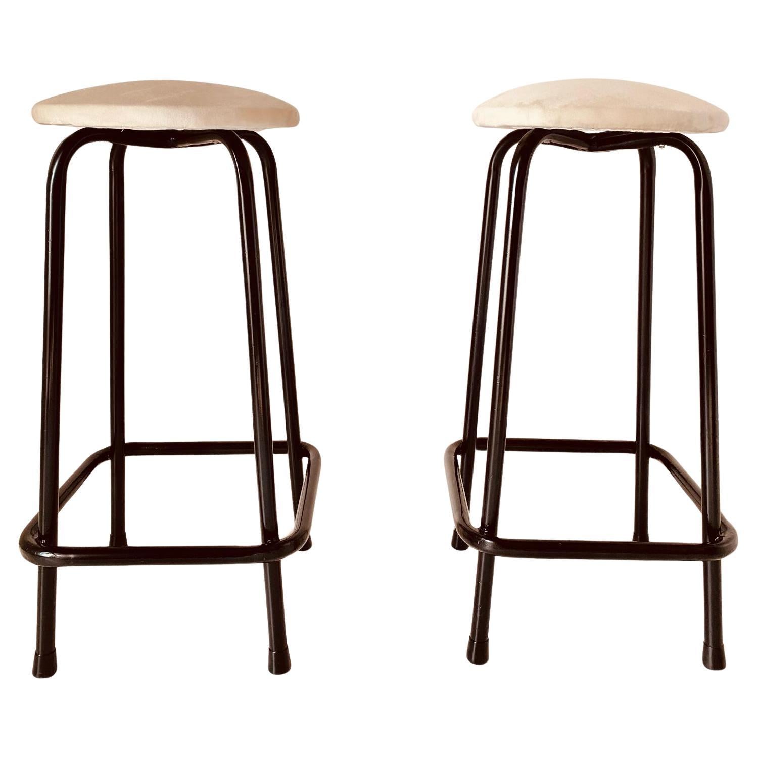 A pair of beautiful vintage velvet stools. Seat in beige velvet with four legs iron black painted legs. Manufactured in Italy in the 1960's. 
Original fabric has been changed with waterproof velvet. Stool structure has been repainted. In excellent